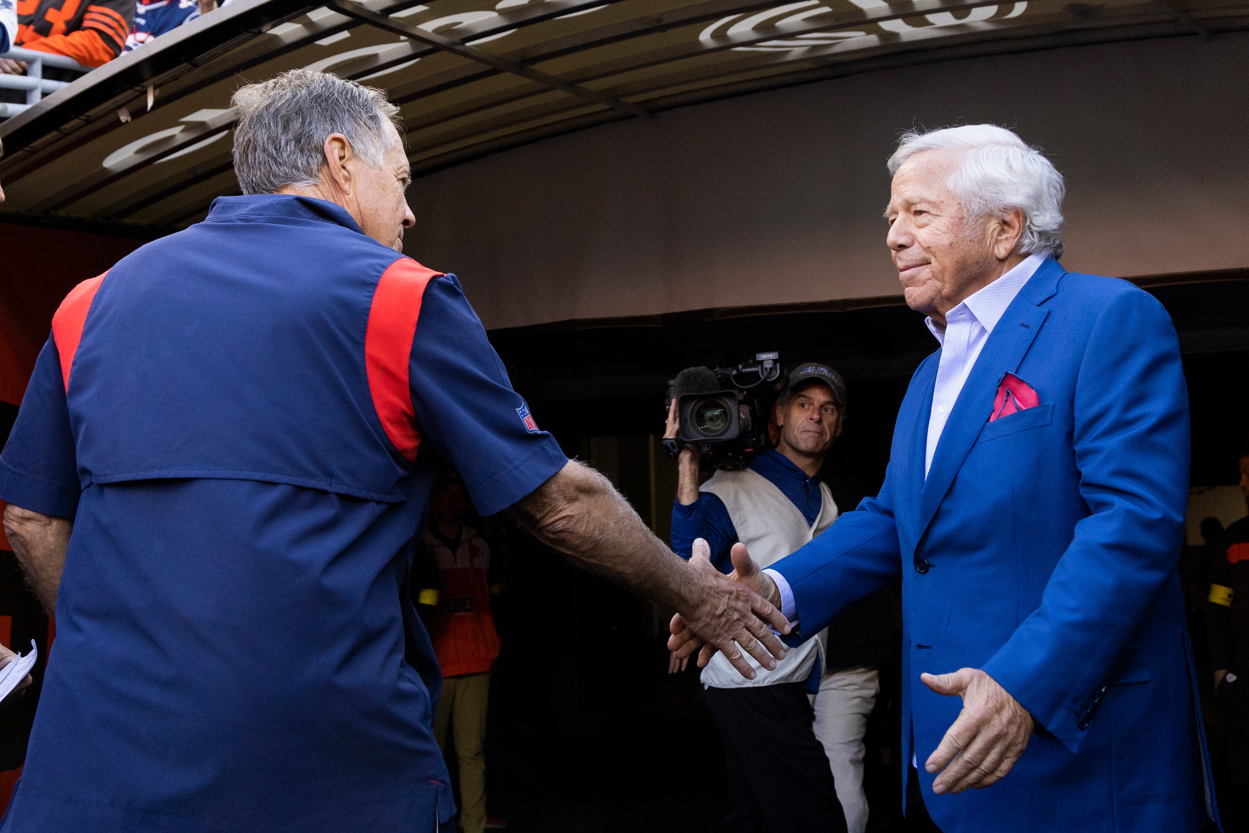 New England Patriots owner Robert Kraft shakes hands with head coach Bill Belichick following the win against the Cleveland Browns at FirstEnergy Stadium