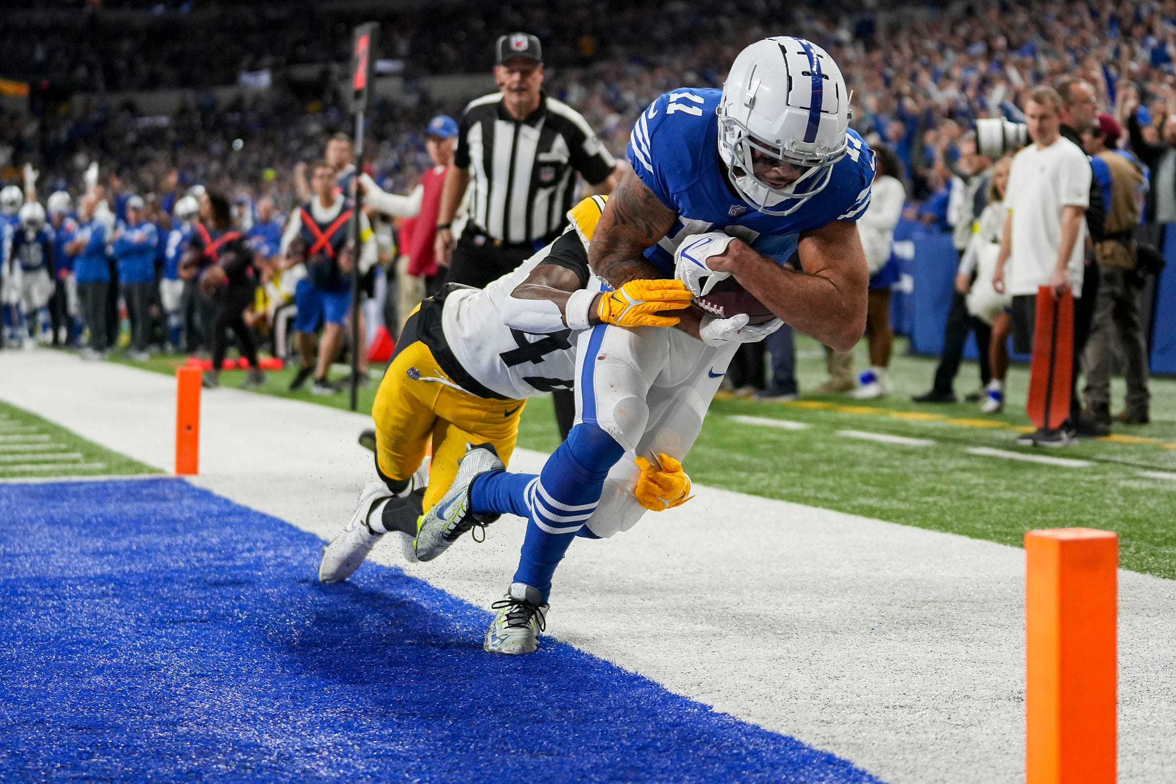 Pittsburgh Steelers cornerback James Pierre (42) tries to bring Indianapolis Colts wide receiver Michael Pittman Jr. (11) down as he scores a touchdown Monday, Nov. 28, 2022, during a game against the Pittsburgh Steelers at Lucas Oil Stadium in Indianapolis.