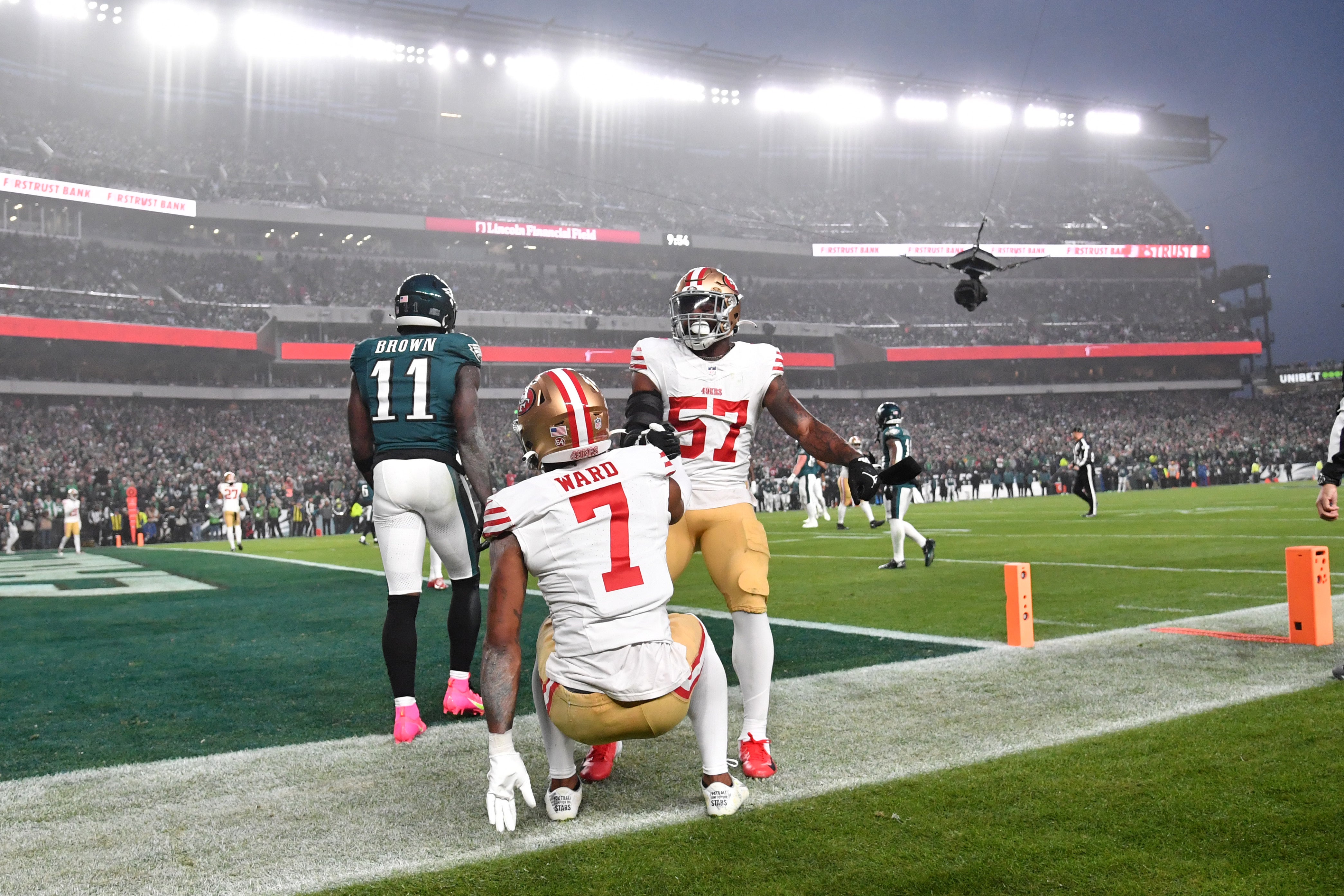 Dec 3, 2023; Philadelphia, Pennsylvania, USA; San Francisco 49ers linebacker Dre Greenlaw (57) helps cornerback Charvarius Ward (7) after making play against Philadelphia Eagles wide receiver A.J. Brown (11) at Lincoln Financial Field.