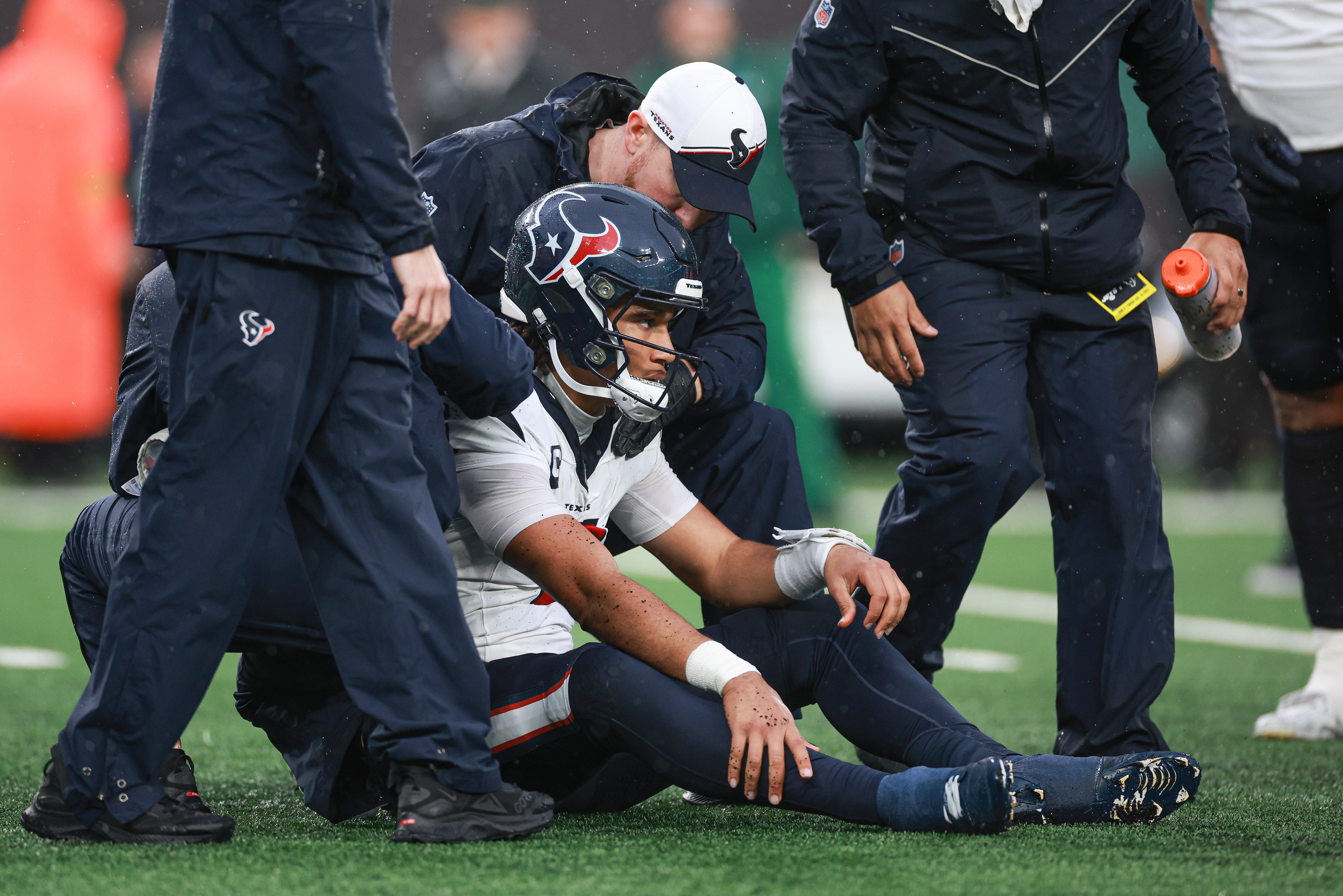 Dec 10, 2023; East Rutherford, New Jersey, USA; Houston Texans quarterback C.J. Stroud (7) with medical staff after suffering an apparent injury during the second half against the New York Jets at MetLife Stadium.