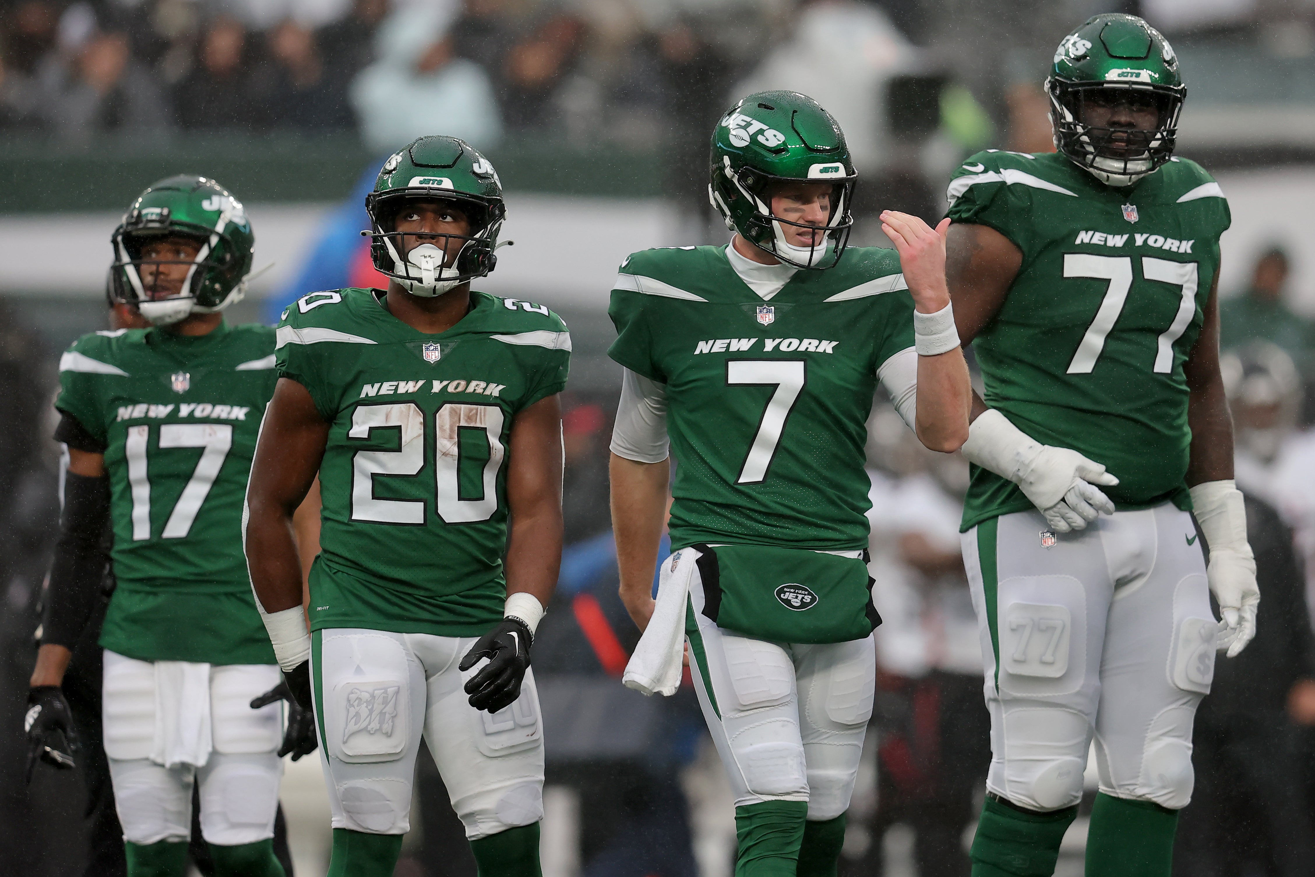 New York Jets quarterback Tim Boyle (7) gestures to a teammate while standing on the field with wide receiver Garrett Wilson (17) and running back Breece Hall (20) and offensive tackle Mekhi Becton (77) during the second quarter against the Atlanta Falcons at MetLife Stadium.