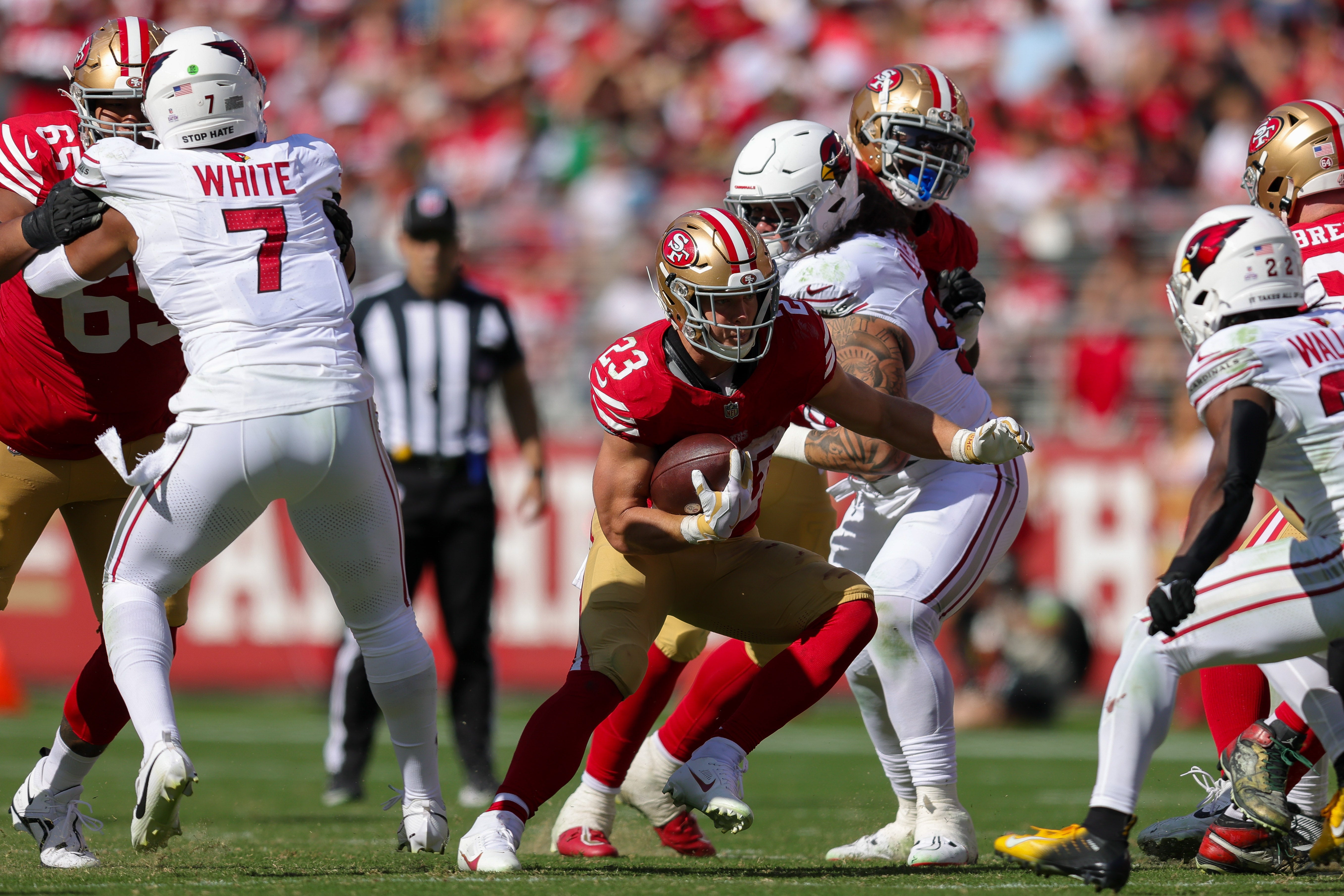 Oct 1, 2023; Santa Clara, California, USA; San Francisco 49ers running back Christian McCaffrey (23) runs with the ball against Arizona Cardinals safety K'Von Wallace (22) during the third quarter at Levi's Stadium.