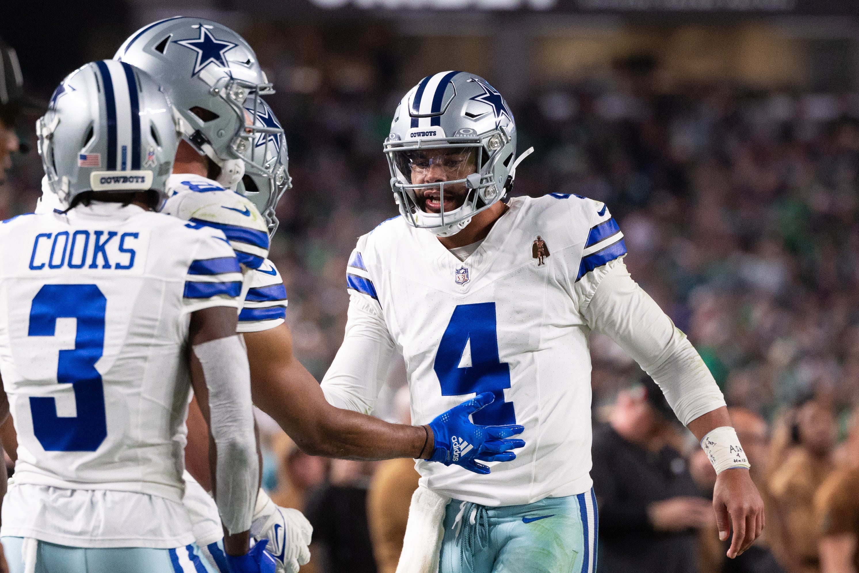 Dallas Cowboys quarterback Dak Prescott (4) celebrates a touchdown with teammates during the fourth quarter against the Philadelphia Eagles at Lincoln Financial Field.