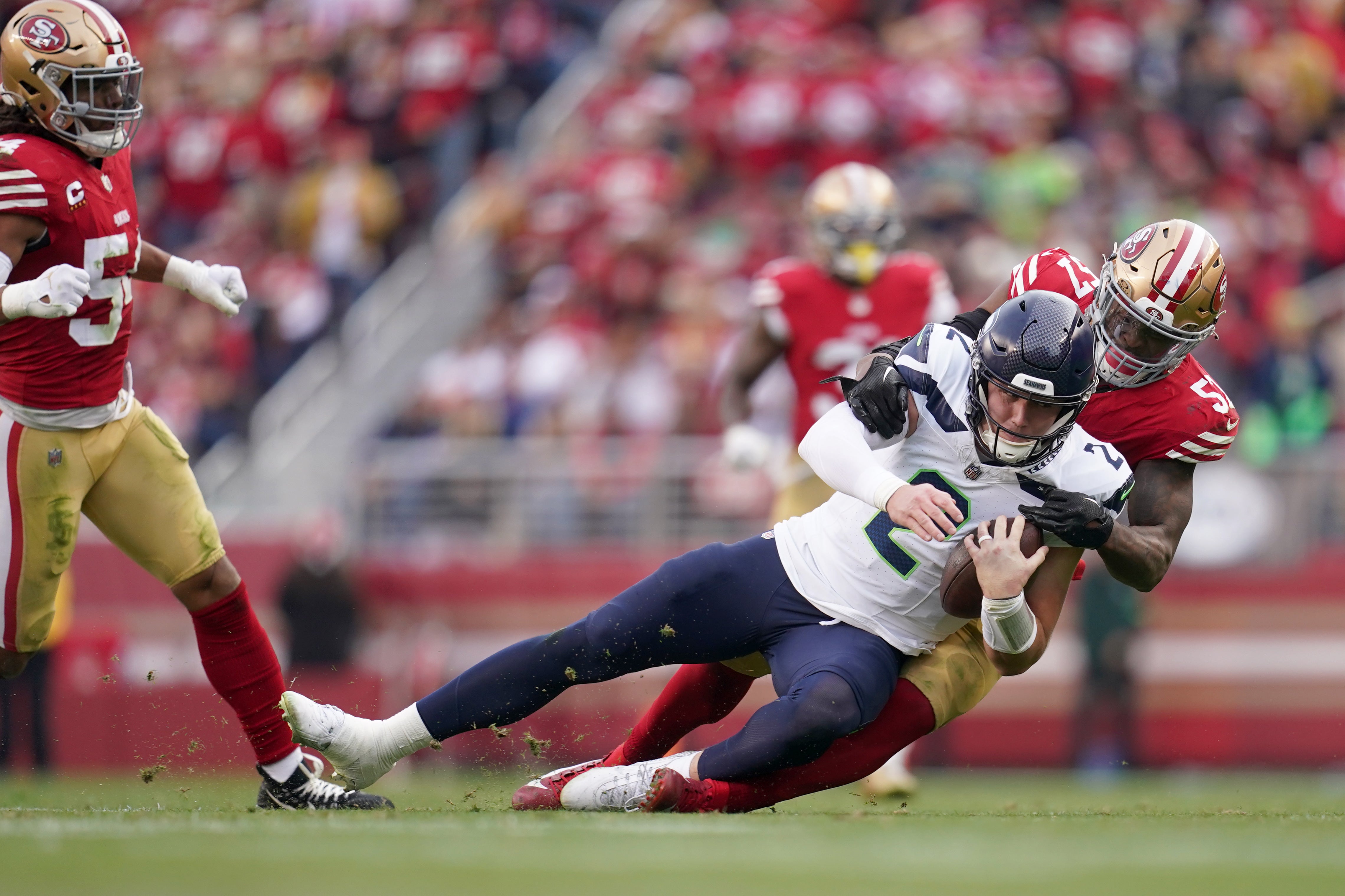 Dec 10, 2023; Santa Clara, California, USA; Seattle Seahawks quarterback Drew Lock (2) is tackled by San Francisco 49ers linebacker Dre Greenlaw (57) in the third quarter at Levi's Stadium.