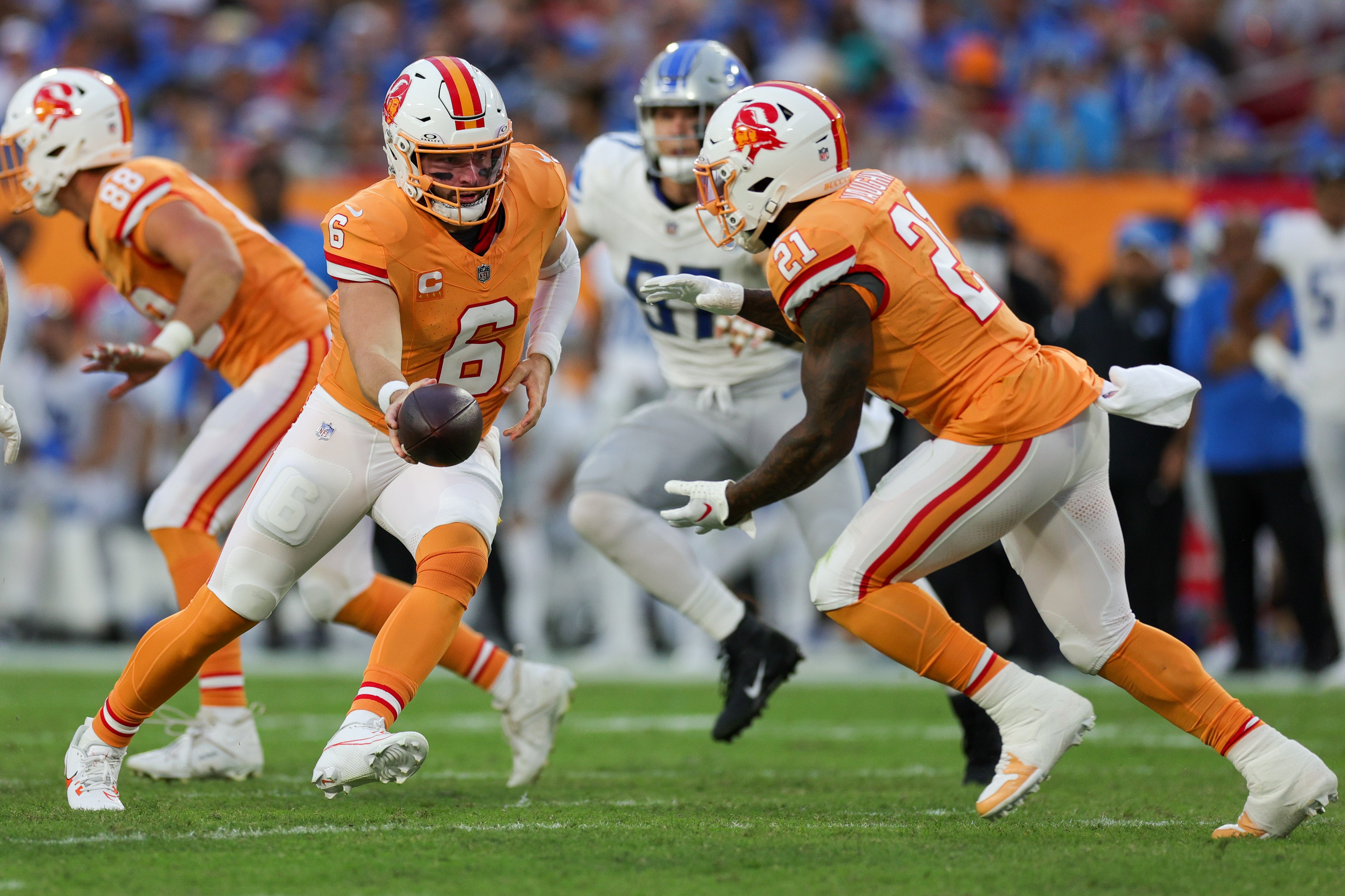 Oct 15, 2023; Tampa, Florida, USA; Tampa Bay Buccaneers quarterback Baker Mayfield (6) hands off to running back Ke'Shawn Vaughn (21) against the Detroit Lions in the third quarter at Raymond James Stadium. Mandatory Credit: Nathan Ray Seebeck-USA TODAY Sports