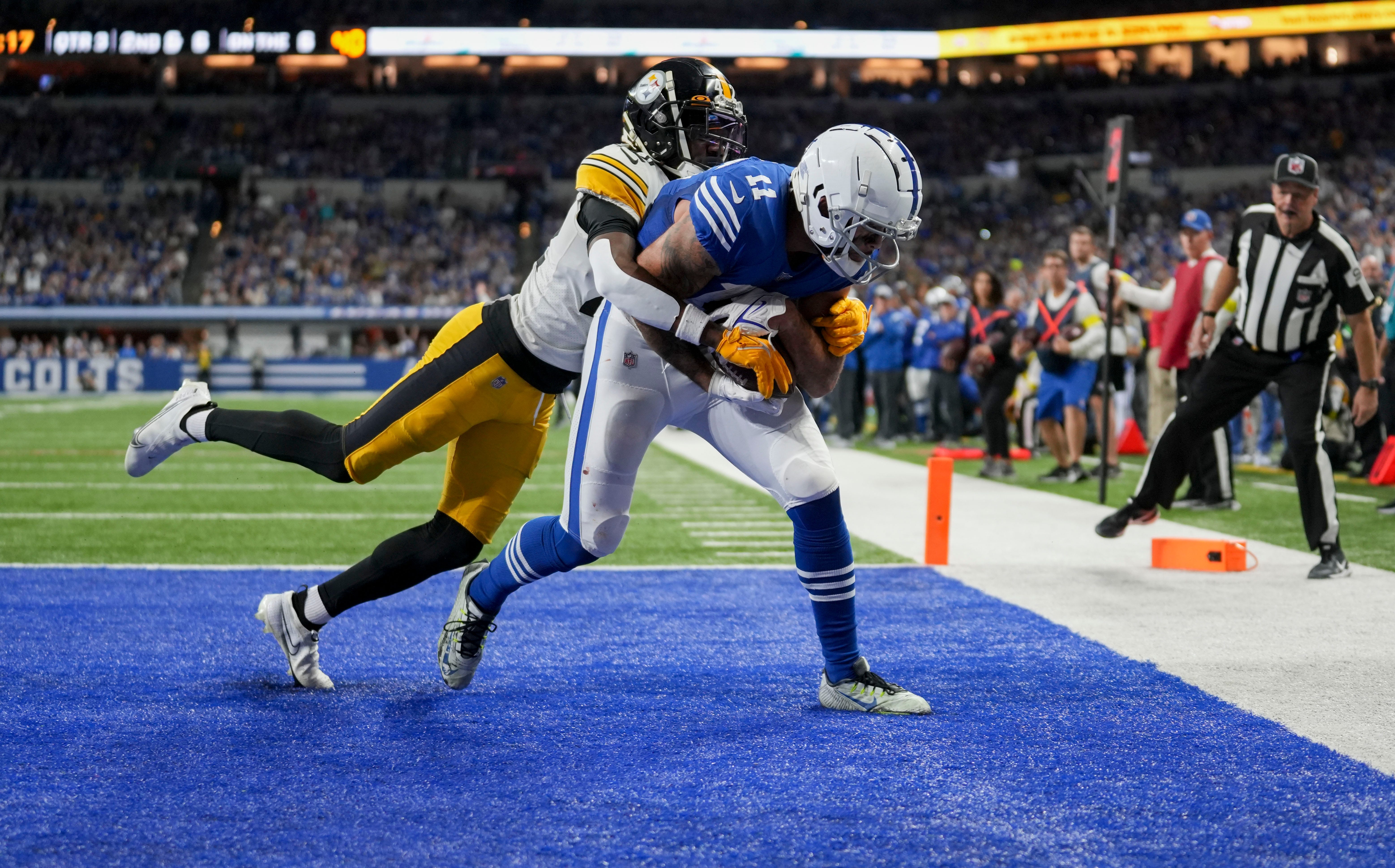 Pittsburgh Steelers cornerback James Pierre (42) tries to bring Indianapolis Colts wide receiver Michael Pittman Jr. (11) down as he scores a touchdown Monday, Nov. 28, 2022, during a game against the Pittsburgh Steelers at Lucas Oil Stadium in Indianapolis.