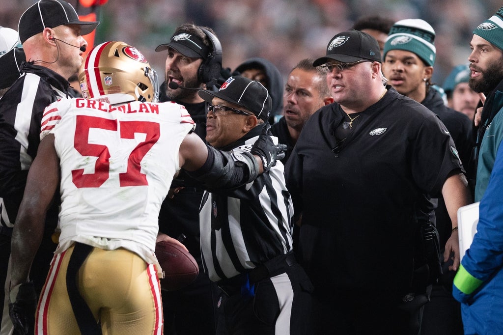 San Francisco 49ers linebacker Dre Greenlaw (57) has an altercation with Philadelphia Eagles staff member Dom DiSandro during the third quarter at Lincoln Financial Field.