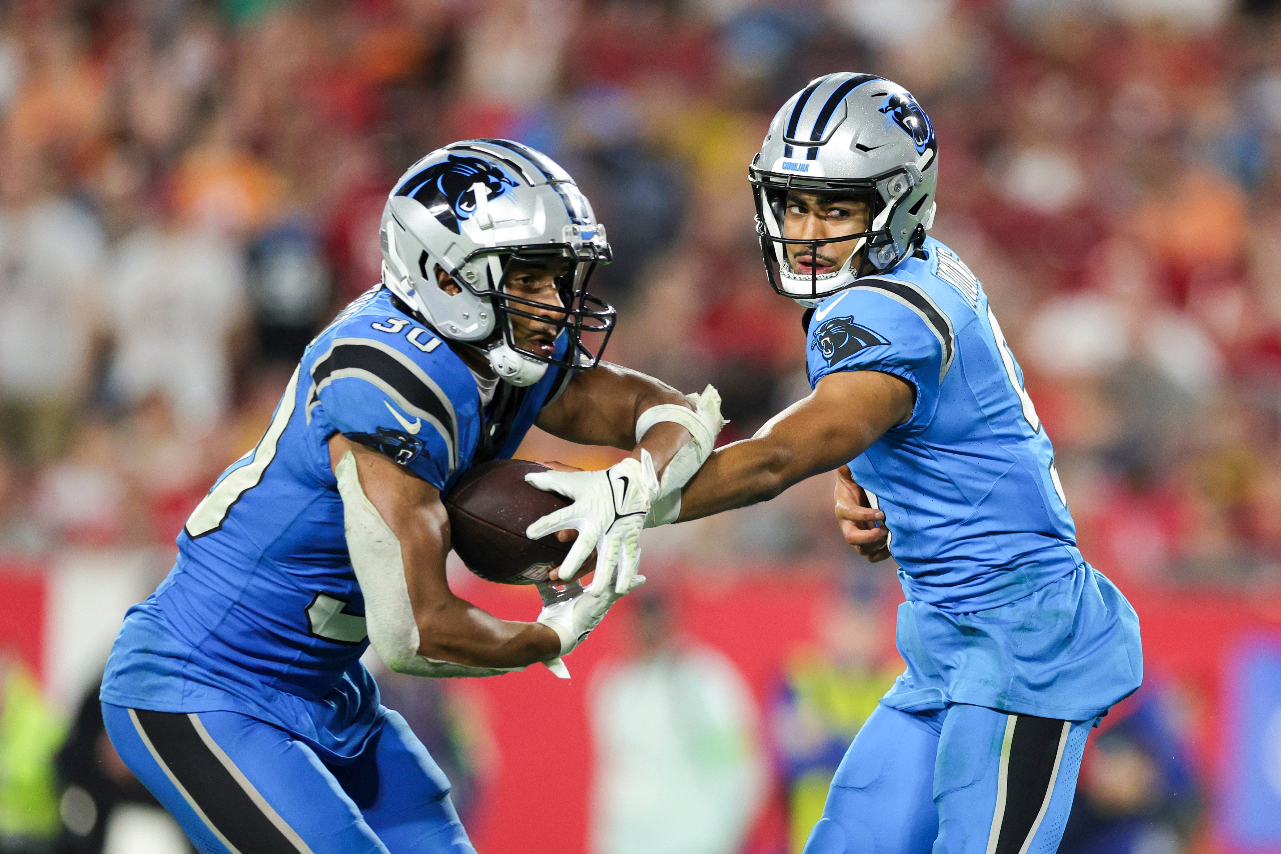 Dec 3, 2023; Tampa, Florida, USA; Carolina Panthers quarterback Bryce Young (9) hands off to running back Raheem Blackshear (3) against the Tampa Bay Buccaneers in the fourth quarter at Raymond James Stadium. Mandatory Credit: Nathan Ray Seebeck-USA TODAY Sports