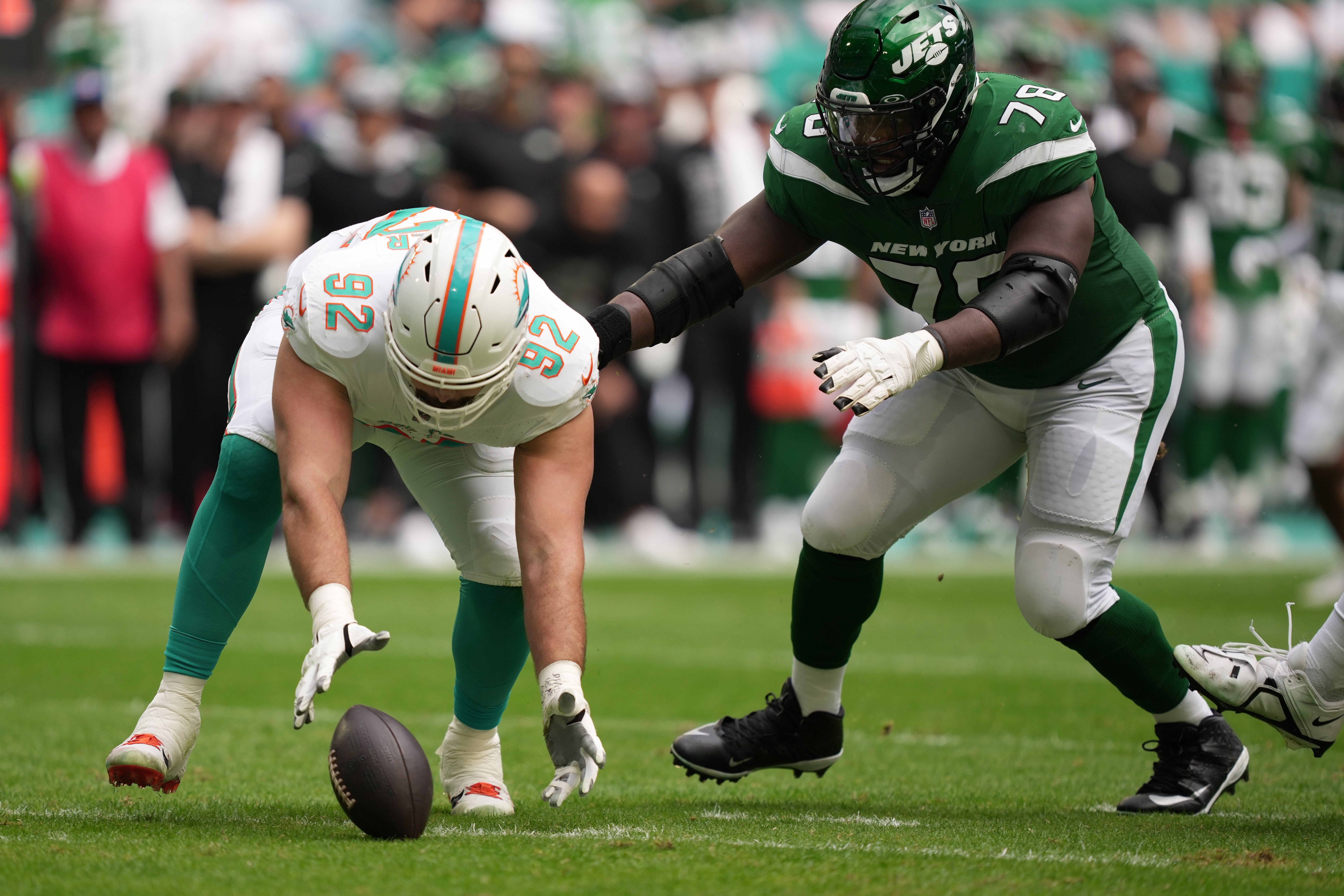 Miami Dolphins defensive tackle Zach Sieler (92) recovers a fumble as New York Jets guard Laken Tomlinson (78) follows on the play during the first half of an NFL game at Hard Rock Stadium in Miami Gardens, Dec. 17, 2023.