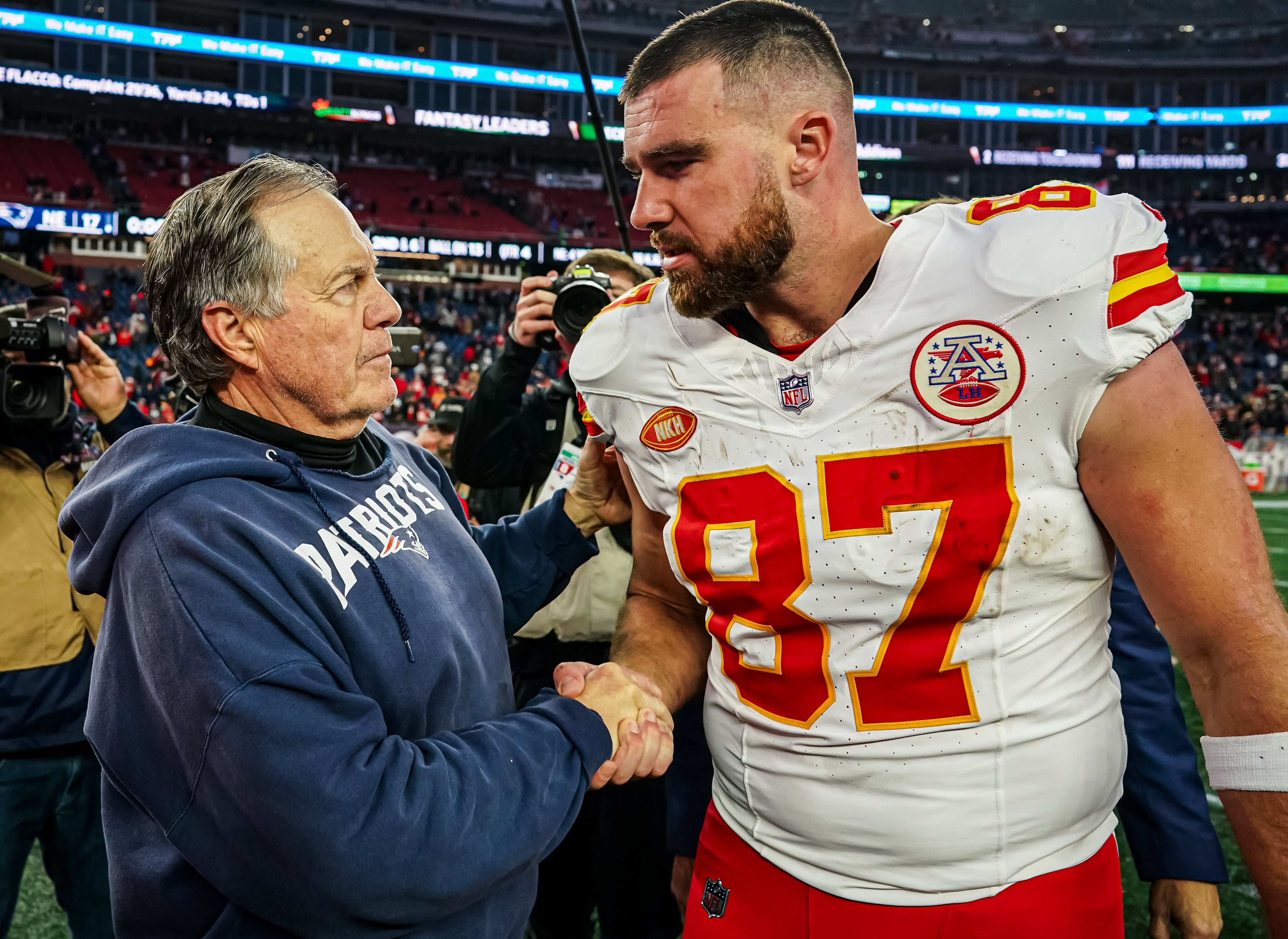 New England Patriots head coach Bill Belichick and Kansas City Chiefs tight end Travis Kelce on the field after the game at Gillette Stadium.