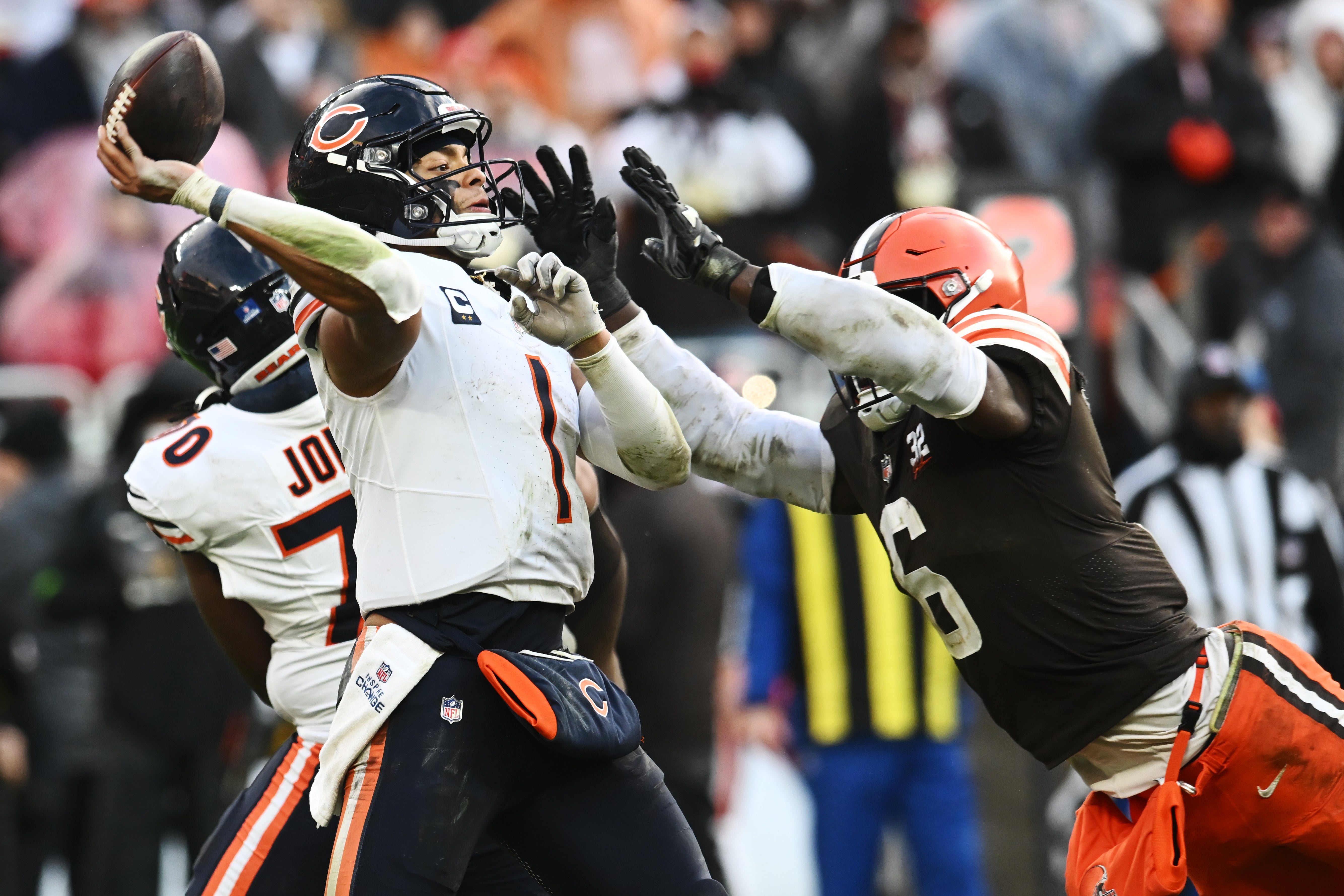 Dec 17, 2023; Cleveland, Ohio, USA; Chicago Bears quarterback Justin Fields (1) throws a pass as Cleveland Browns linebacker Jeremiah Owusu-Koramoah (6) rushes during the second half at Cleveland Browns Stadium.