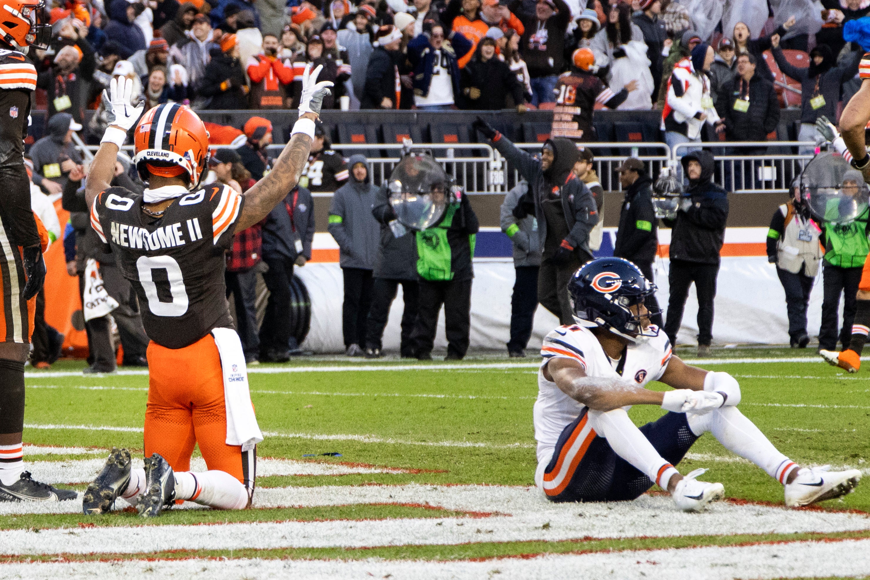 Dec 17, 2023; Cleveland, Ohio, USA; Cleveland Browns cornerback Greg Newsome II (0) celebrates the team s win as Chicago Bears wide receiver Darnell Mooney (11) sits near him following a missed catch for the final play of the game at Cleveland Browns Stadium.