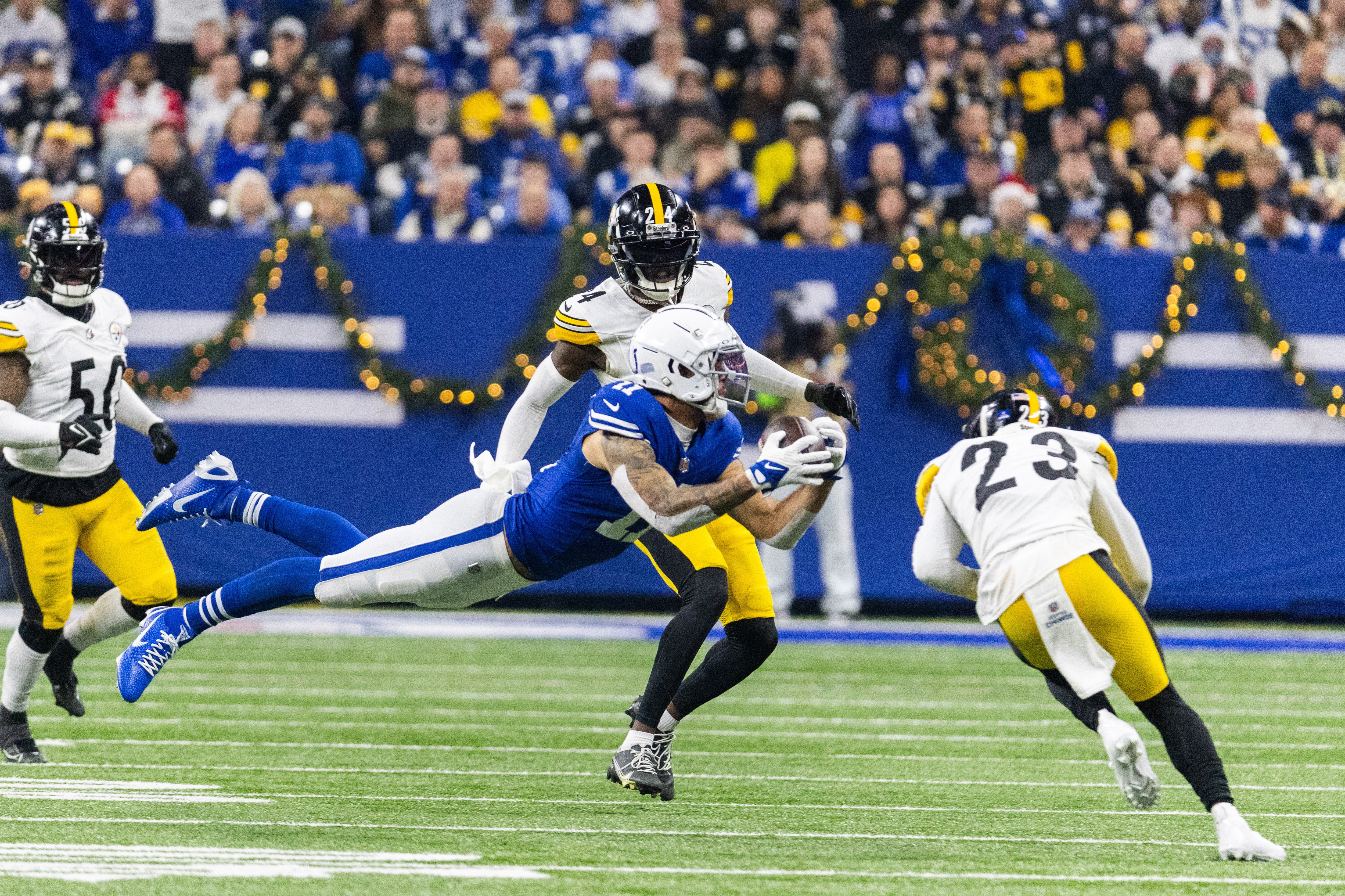 Dec 16, 2023; Indianapolis, Indiana, USA; Indianapolis Colts wide receiver Michael Pittman Jr. (11) dives for a catch while Pittsburgh Steelers safety Damontae Kazee (23) defends in the first half at Lucas Oil Stadium.