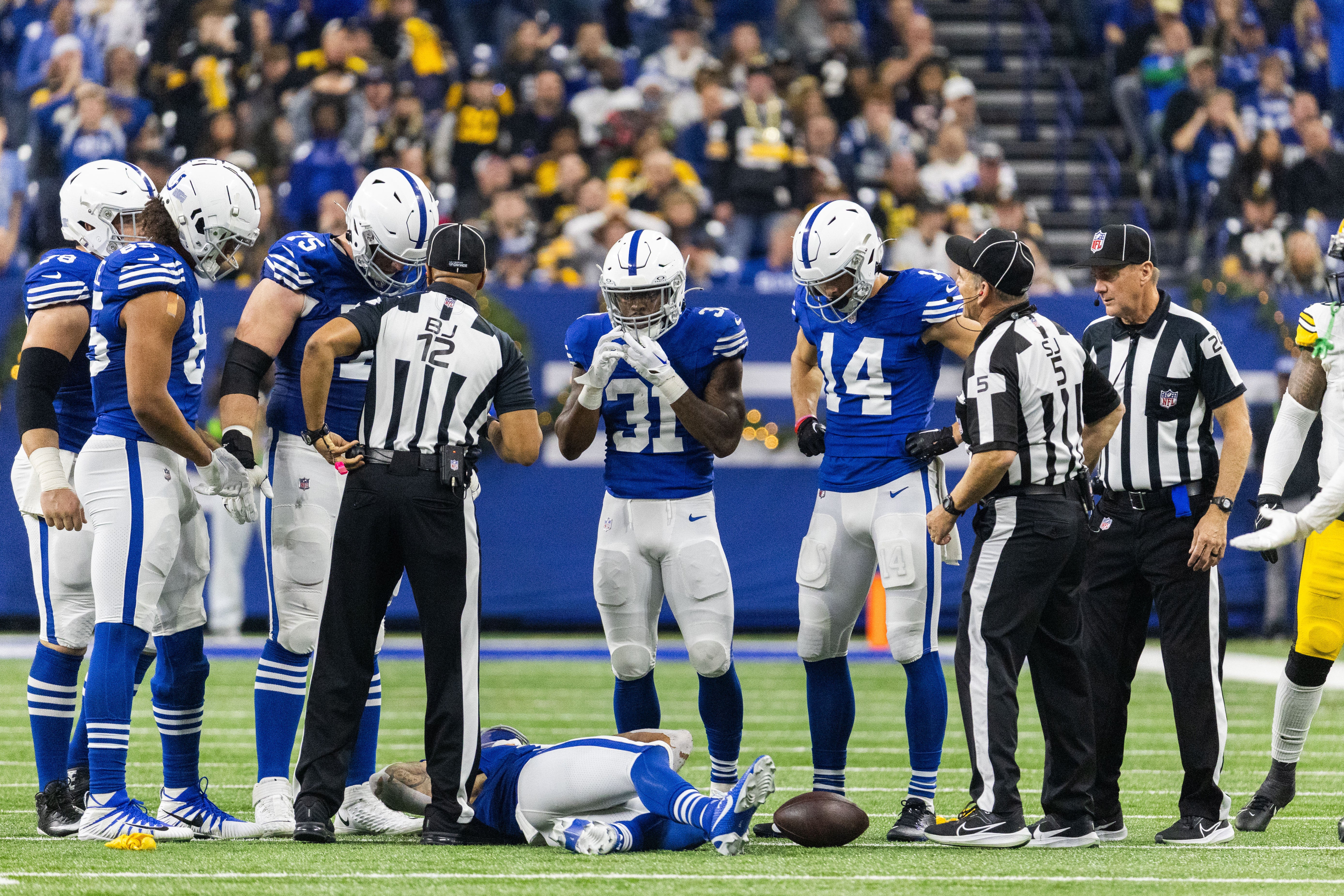 Dec 16, 2023; Indianapolis, Indiana, USA; The Indianapolis Colts stand around receiver Michael Pittman Jr. (11) after a targeting hit in the first half against the Pittsburgh Steelers at Lucas Oil Stadium.