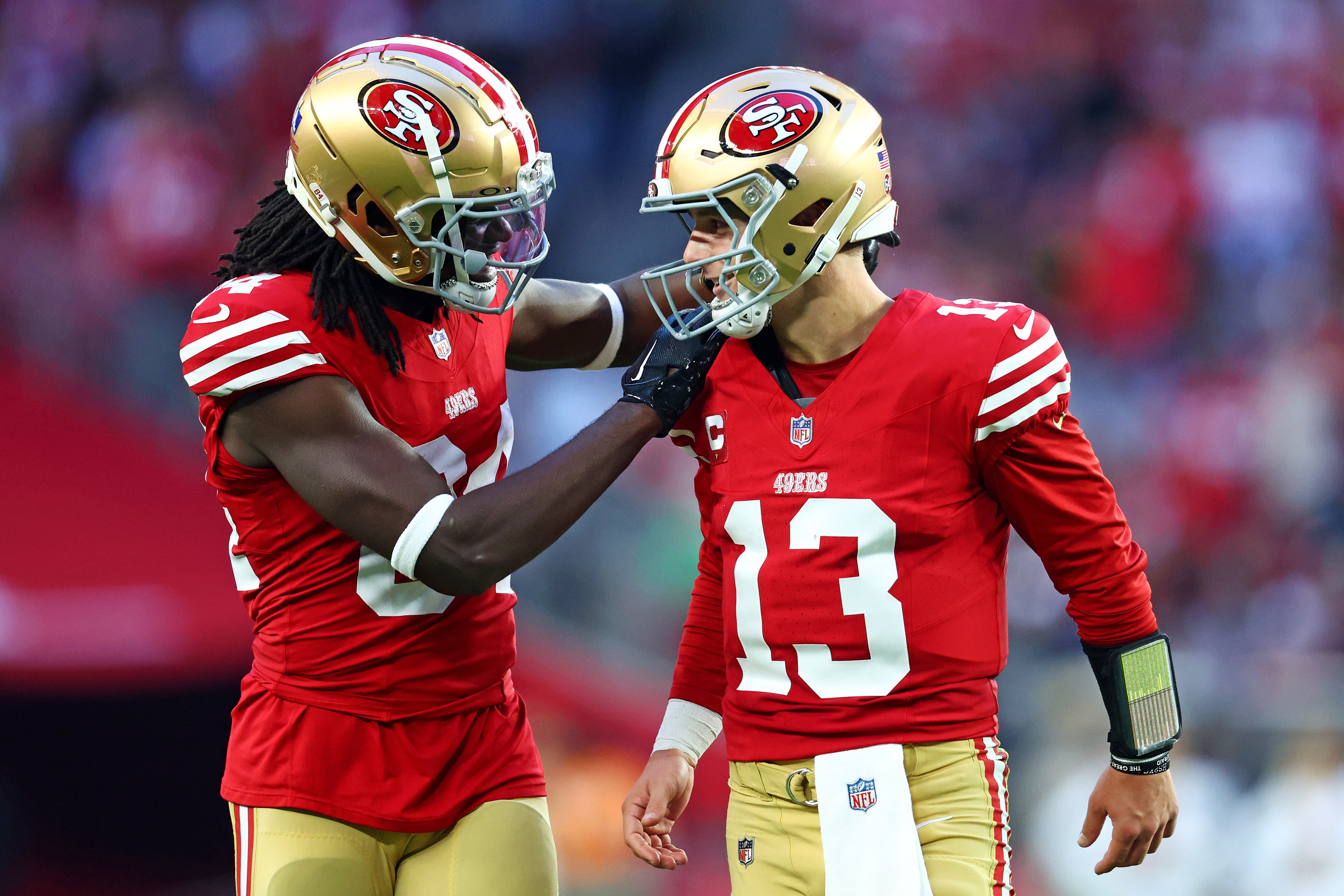 Dec 17, 2023; Glendale, Arizona, USA; San Francisco 49ers quarterback Brock Purdy (13) celebrates with San Francisco 49ers wide receiver Chris Conley (84) after a play during the fourth quarter against the Arizona Cardinals at State Farm Stadium.