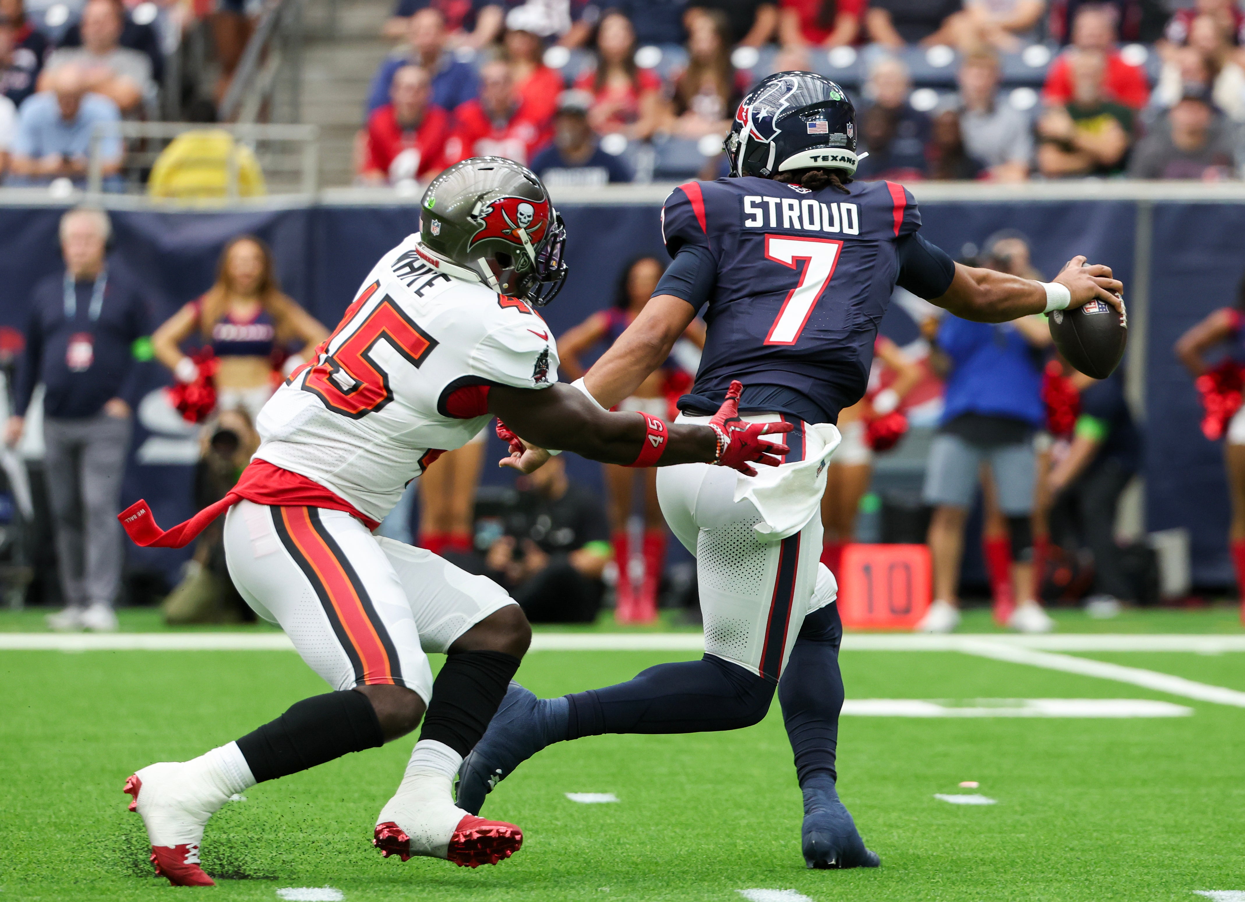 Nov 5, 2023; Houston, Texas, USA; Houston Texans quarterback C.J. Stroud (7) escapes the grasp on Tampa Bay Buccaneers linebacker Devin White (45) in the first quarter at NRG Stadium. Mandatory Credit: Thomas Shea-USA TODAY Sports