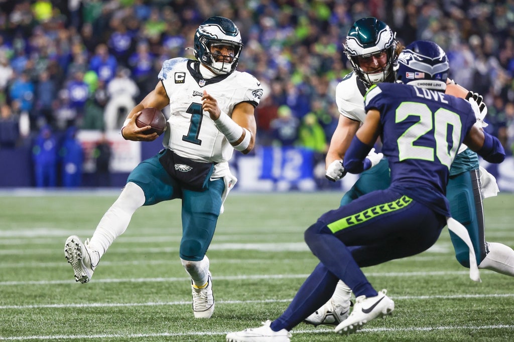 Philadelphia Eagles quarterback Jalen Hurts (1) rushes against the Seattle Seahawks during the second quarter at Lumen Field.
