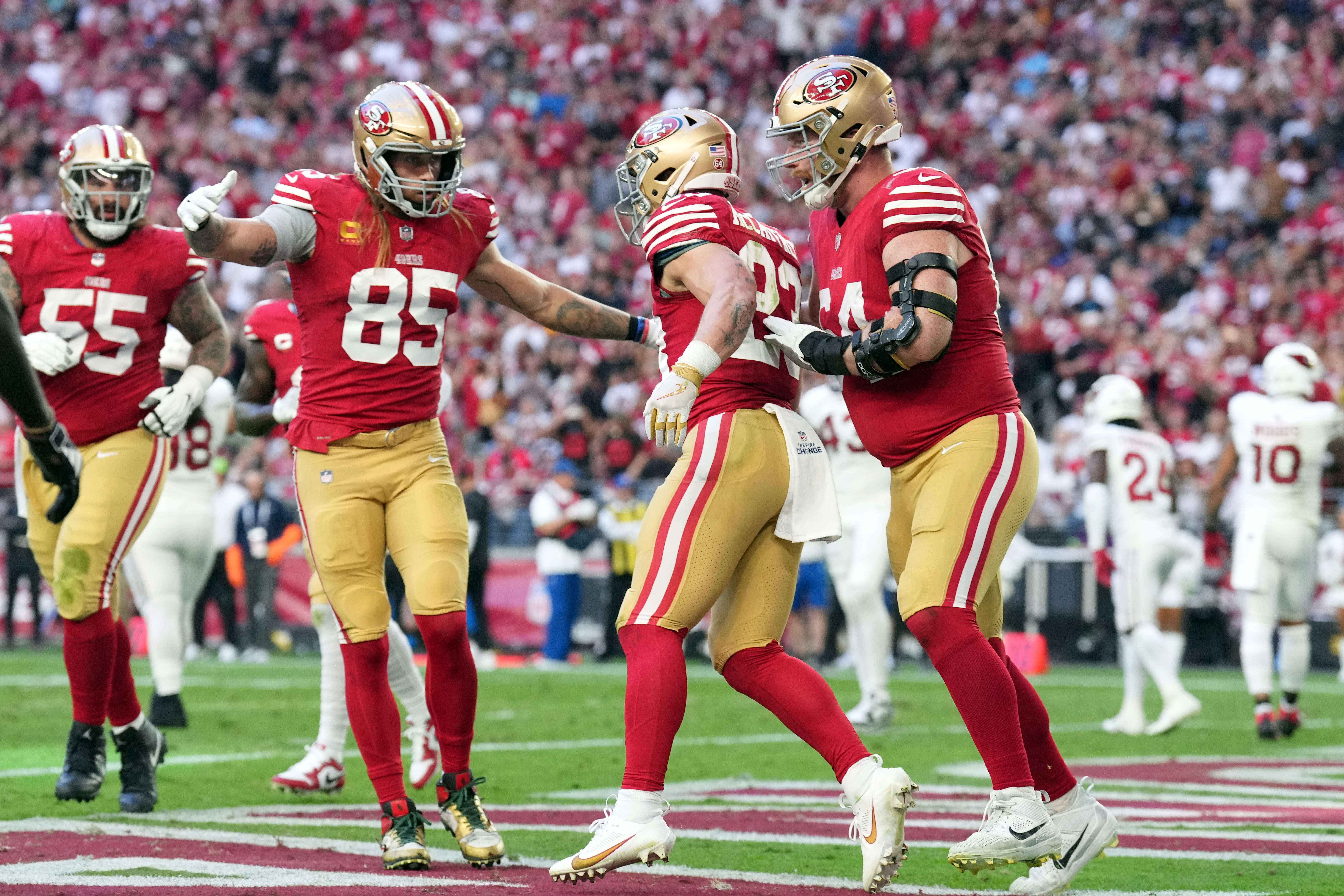 Dec 17, 2023; Glendale, Arizona, USA; San Francisco 49ers running back Christian McCaffrey (23) celebrates a touchdown against the Arizona Cardinals during the first half at State Farm Stadium.