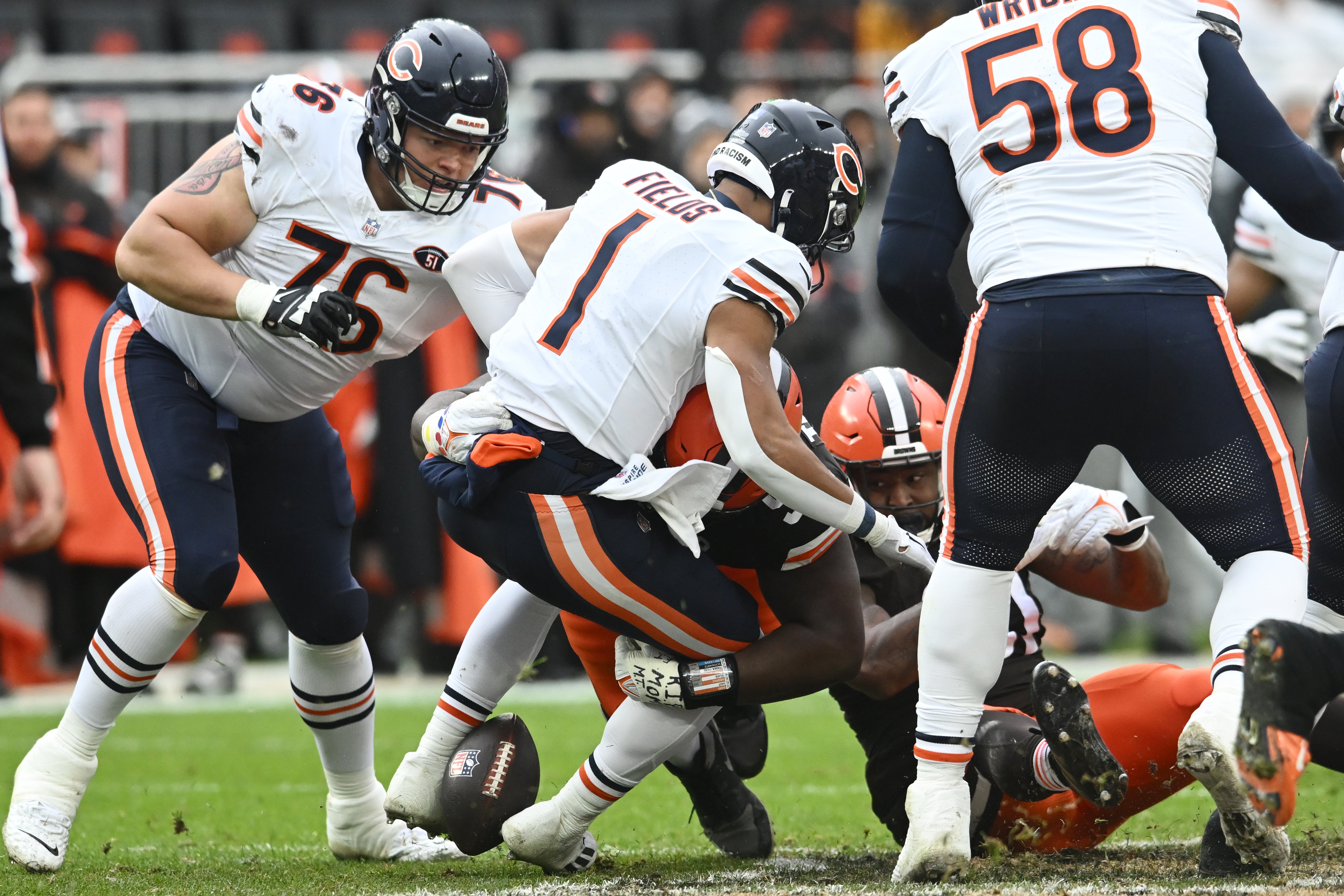 Dec 17, 2023; Cleveland, Ohio, USA; Cleveland Browns defensive tackle Dalvin Tomlinson (94) forces a fumble on Chicago Bears quarterback Justin Fields (1) during the first quarter at Cleveland Browns Stadium.