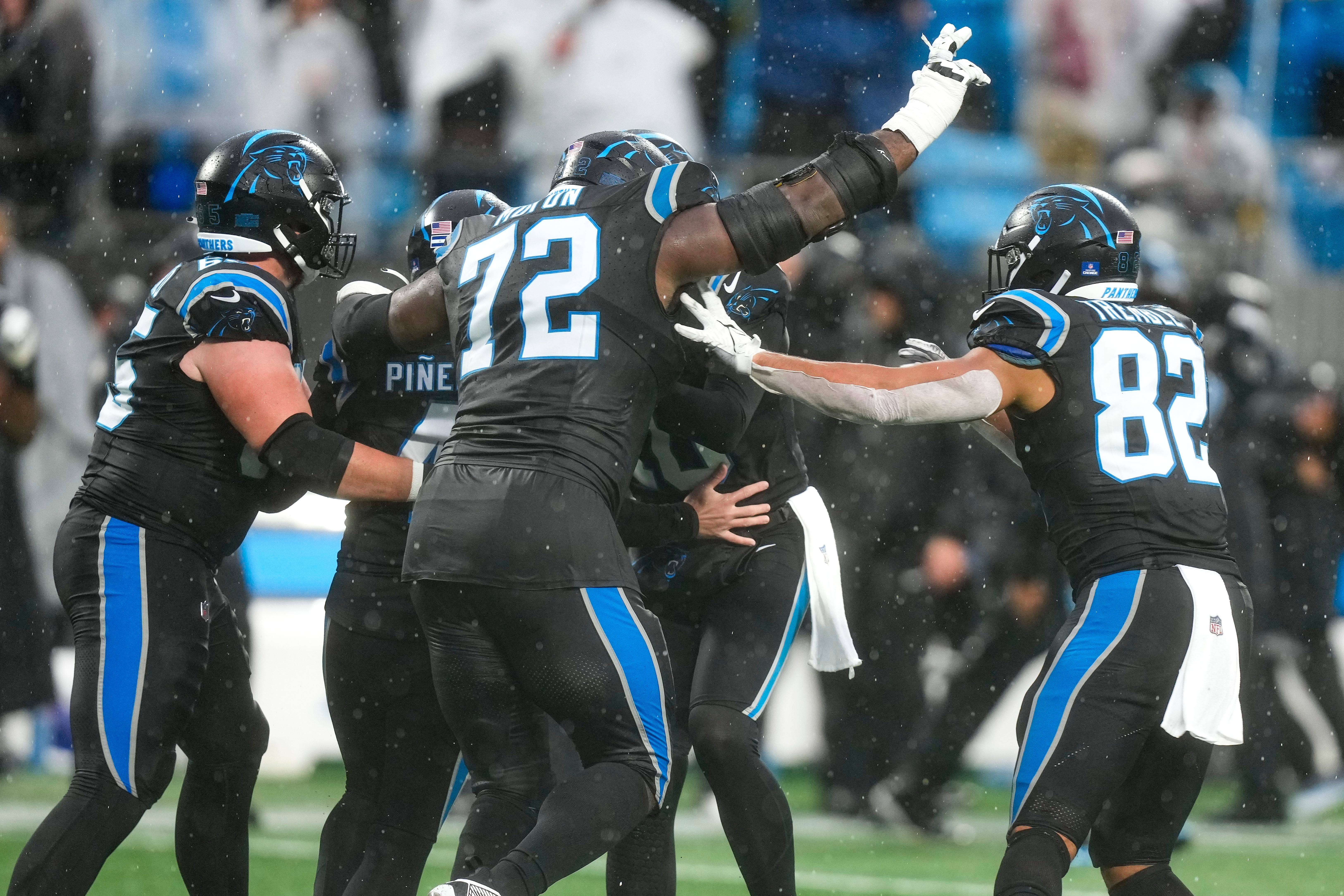 Dec 17, 2023; Charlotte, North Carolina, USA; Carolina Panthers place kicker Eddy Pineiro (4) is swarmed by teammates after he kicks the winning field goal against the Atlanta Falcons during the second half at Bank of America Stadium. Mandatory Credit: Jim Dedmon-USA TODAY Sports