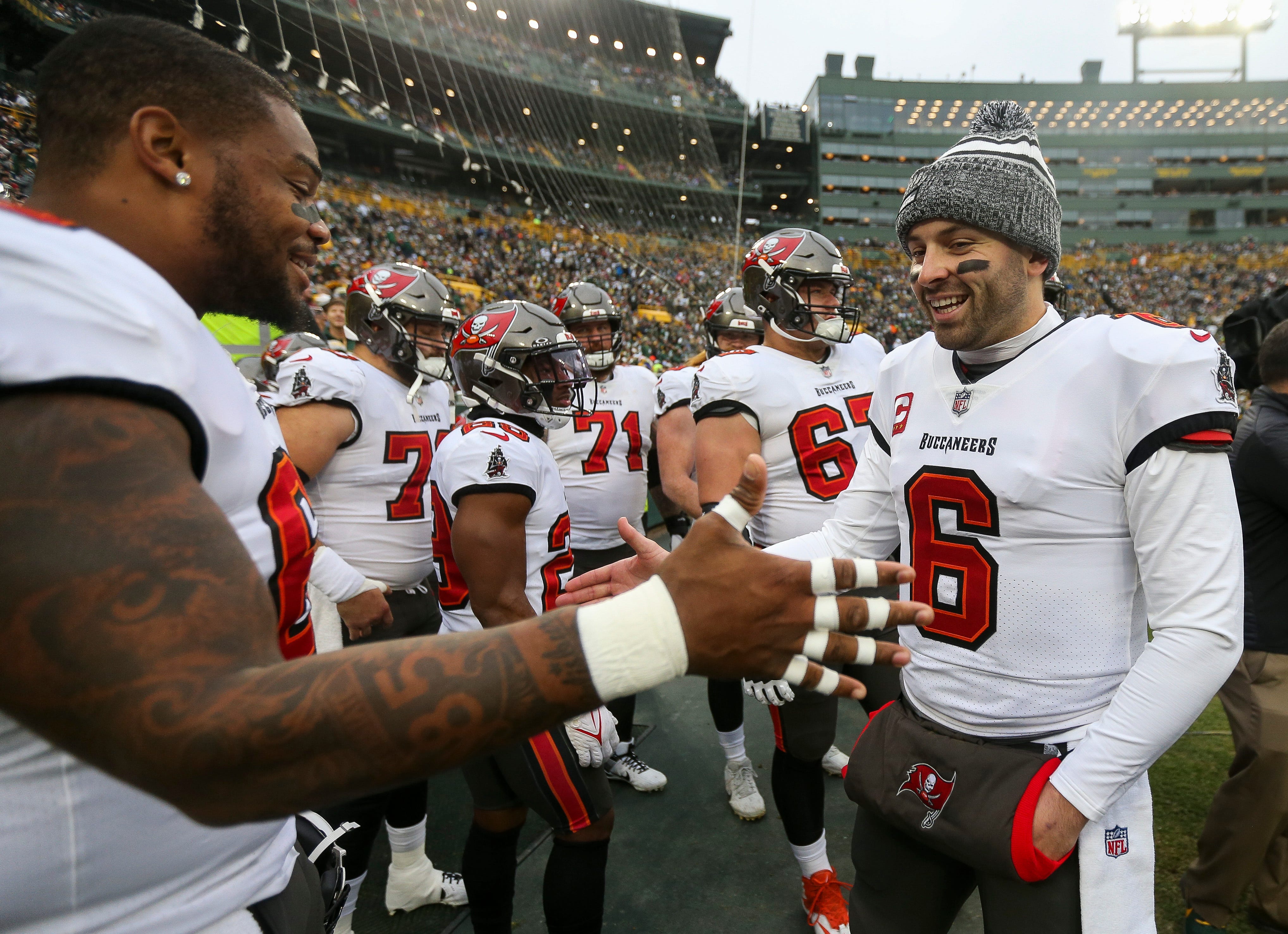 Tampa Bay Buccaneers quarterback Baker Mayfield (6) slaps hands with guard Nick Leverett (left) before taking the field for warmups on Sunday, December 17, 2023, at Lambeau Field in Green Bay, Wis. Tampa Bay defeated the Green Bay Packers, 34-20.