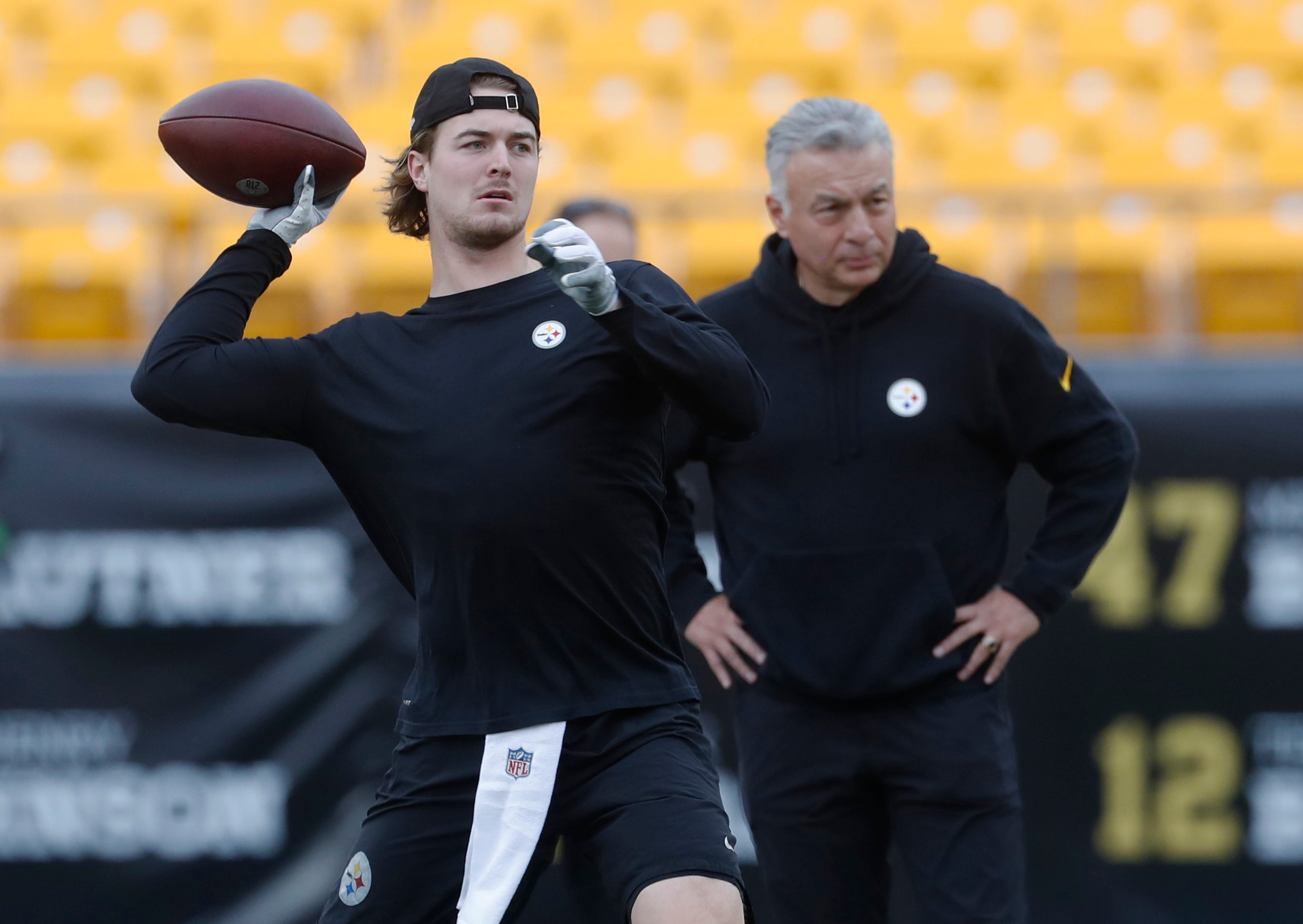 Dec 3, 2023; Pittsburgh, Pennsylvania, USA; Pittsburgh Steelers quarterback Kenny Pickett (8) throws on the field as quarterbacks coach Mike Sullivan (right) looks on before the game against the Arizona Cardinals at Acrisure Stadium. Mandatory Credit: Charles LeClaire-USA TODAY Sports