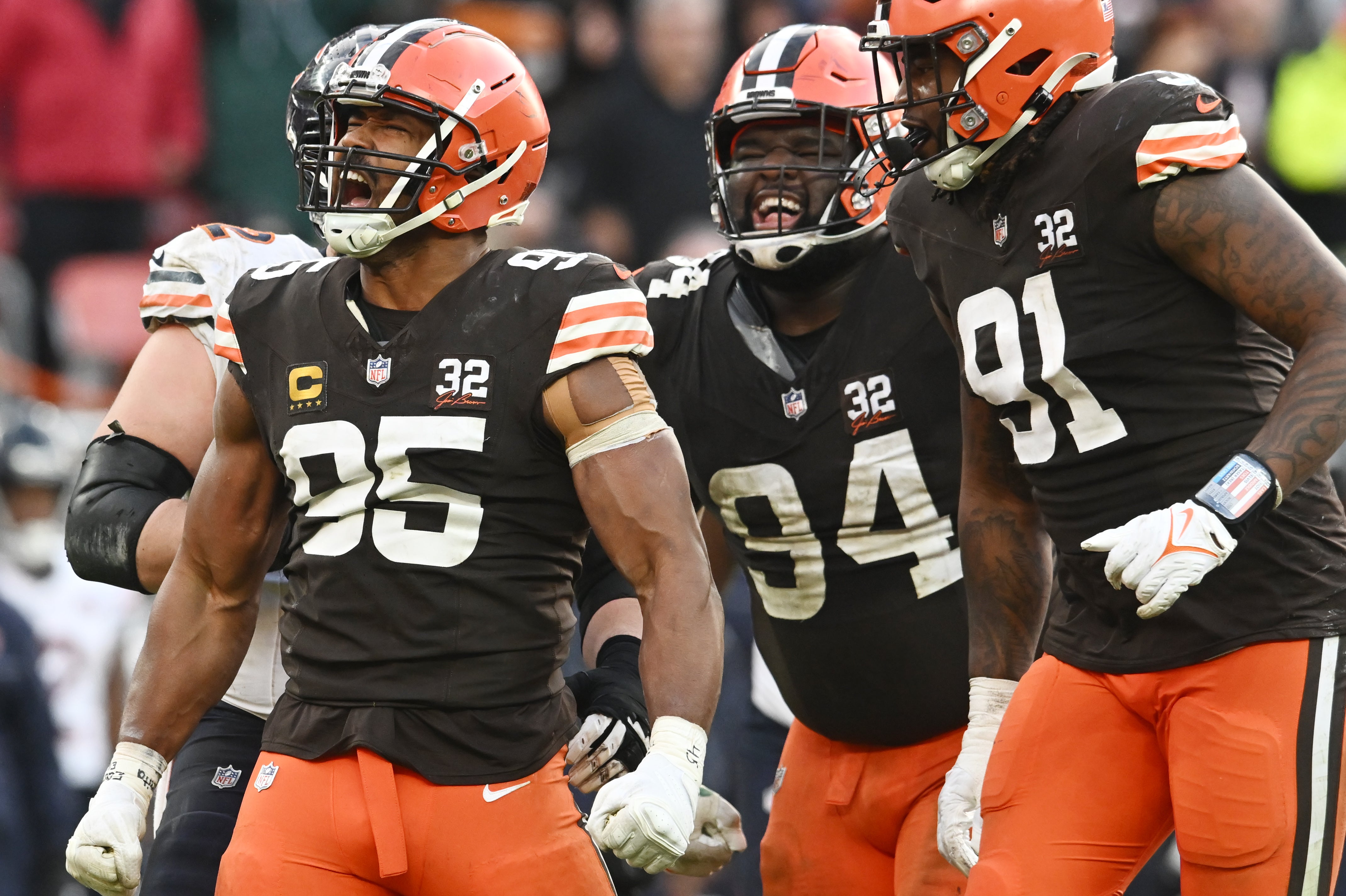 Dec 17, 2023; Cleveland, Ohio, USA; Cleveland Browns defensive end Myles Garrett (95) and defensive tackle Dalvin Tomlinson (94) and defensive end Alex Wright (91) celebrate after a tackle during the second half against the Chicago Bears at Cleveland Browns Stadium. Mandatory Credit: Ken Blaze-USA TODAY Sports