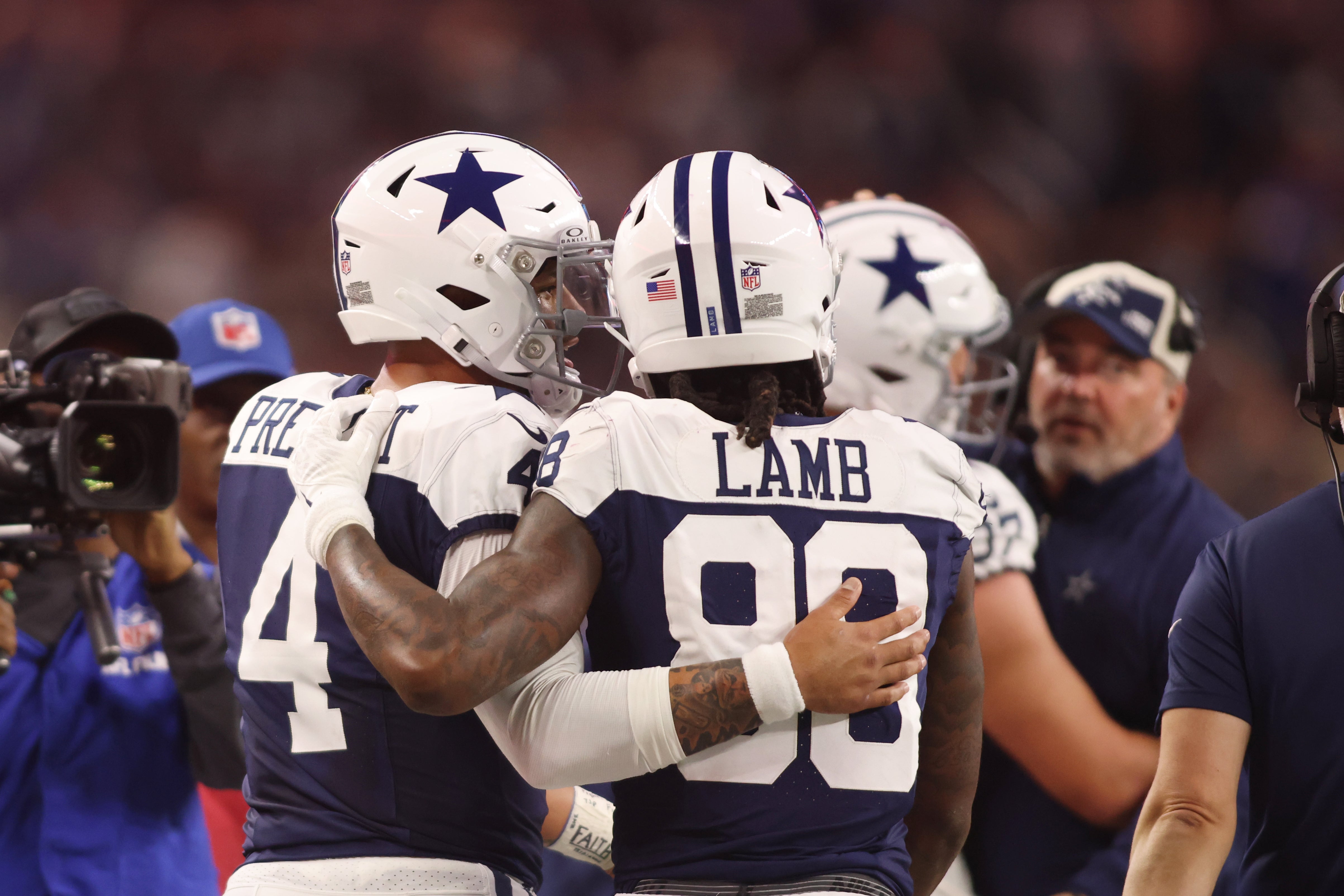 Dallas Cowboys wide receiver CeeDee Lamb (88) and quarterback Dak Prescott (4) talk during the game against the Washington Commanders at AT&T Stadium.