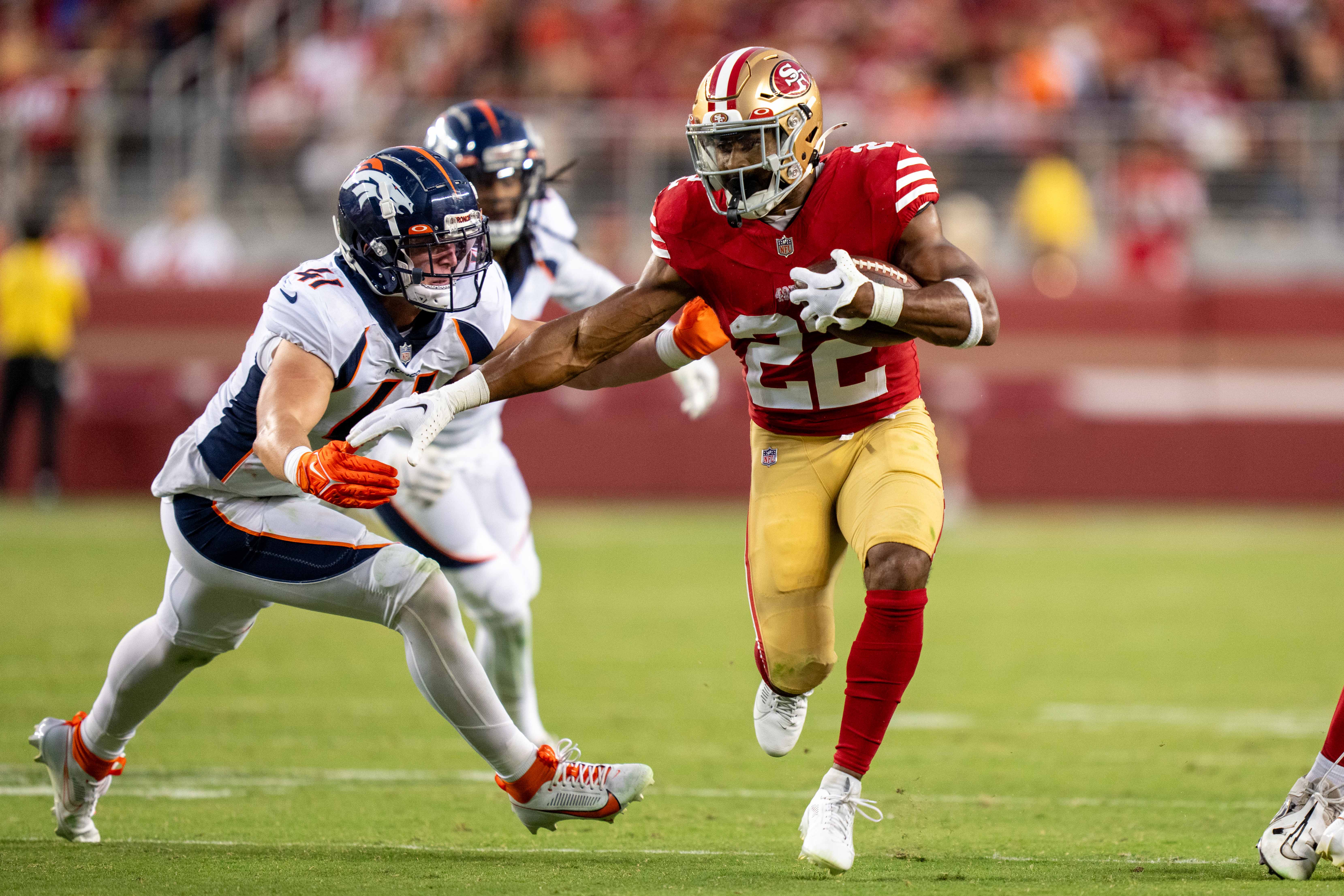 August 19, 2023; Santa Clara, California, USA; San Francisco 49ers running back Jeremy McNichols (22) carries the football against Denver Broncos linebacker Drew Sanders (41) during the fourth quarter at Levi's Stadium.