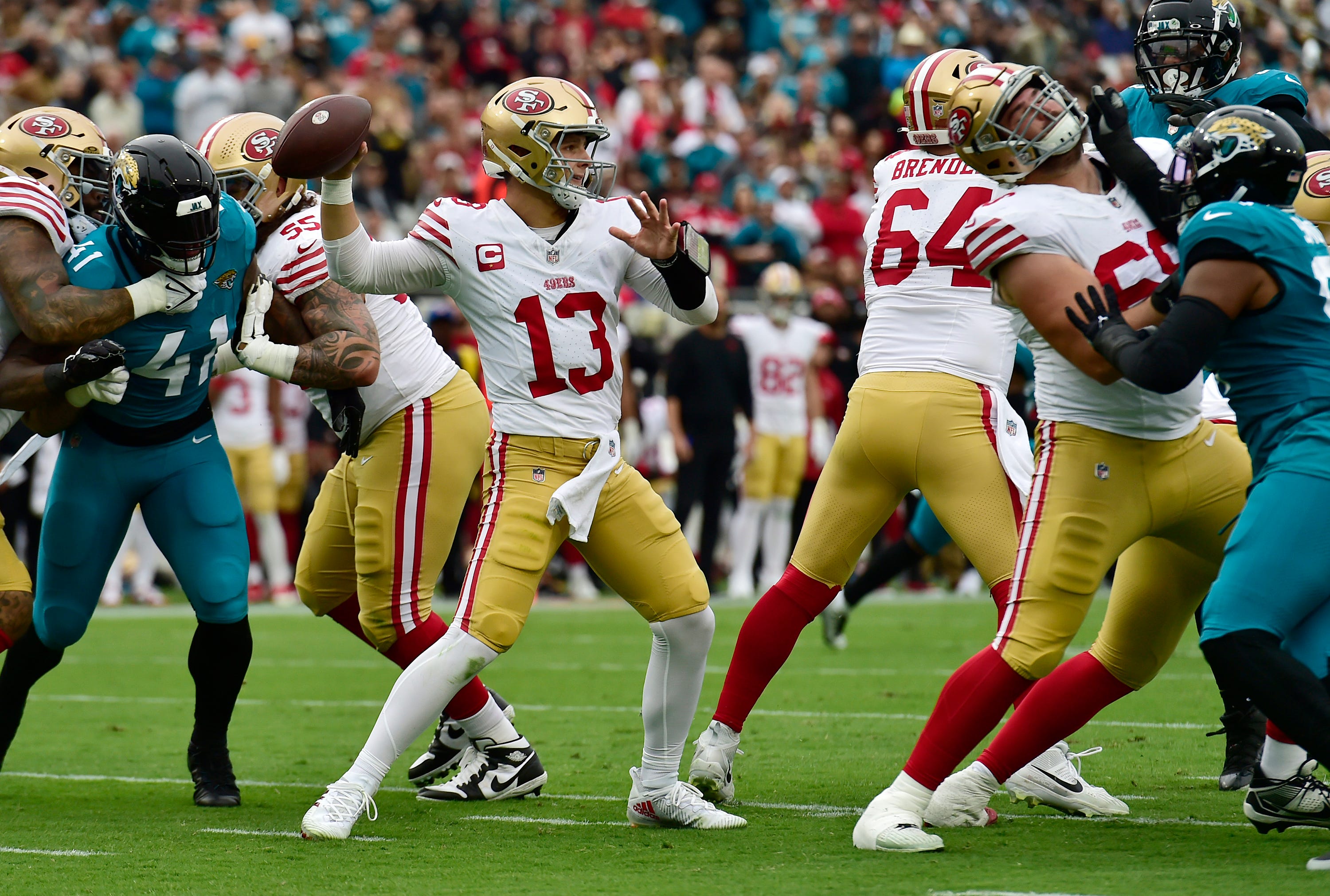 The San Francisco 49ers offensive line buys quarterback Brock Purdy (13) time as he targets a receiver late in the first quarter. The Jacksonville Jaguars hosted the San Francisco 49ers at EverBank Stadium in Jacksonville, FL Sunday, November 12, 2023.