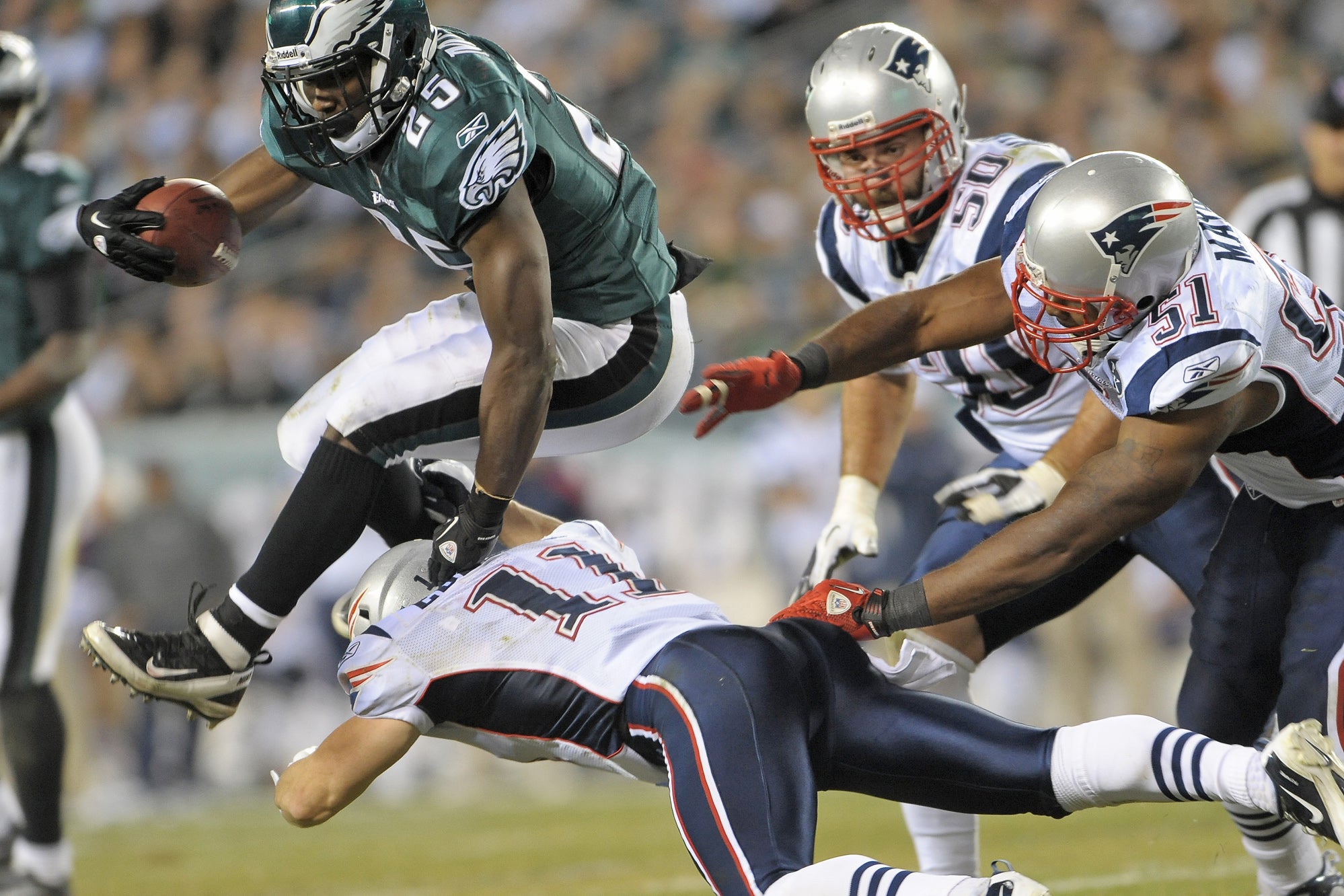 Philadelphia Eagles running back LeSean McCoy hurdles New England Patriots defenders Julian Edelman and Jerod Mayo during game at Lincoln Financial Field. The Patriots defeated the Eagles 38-20.