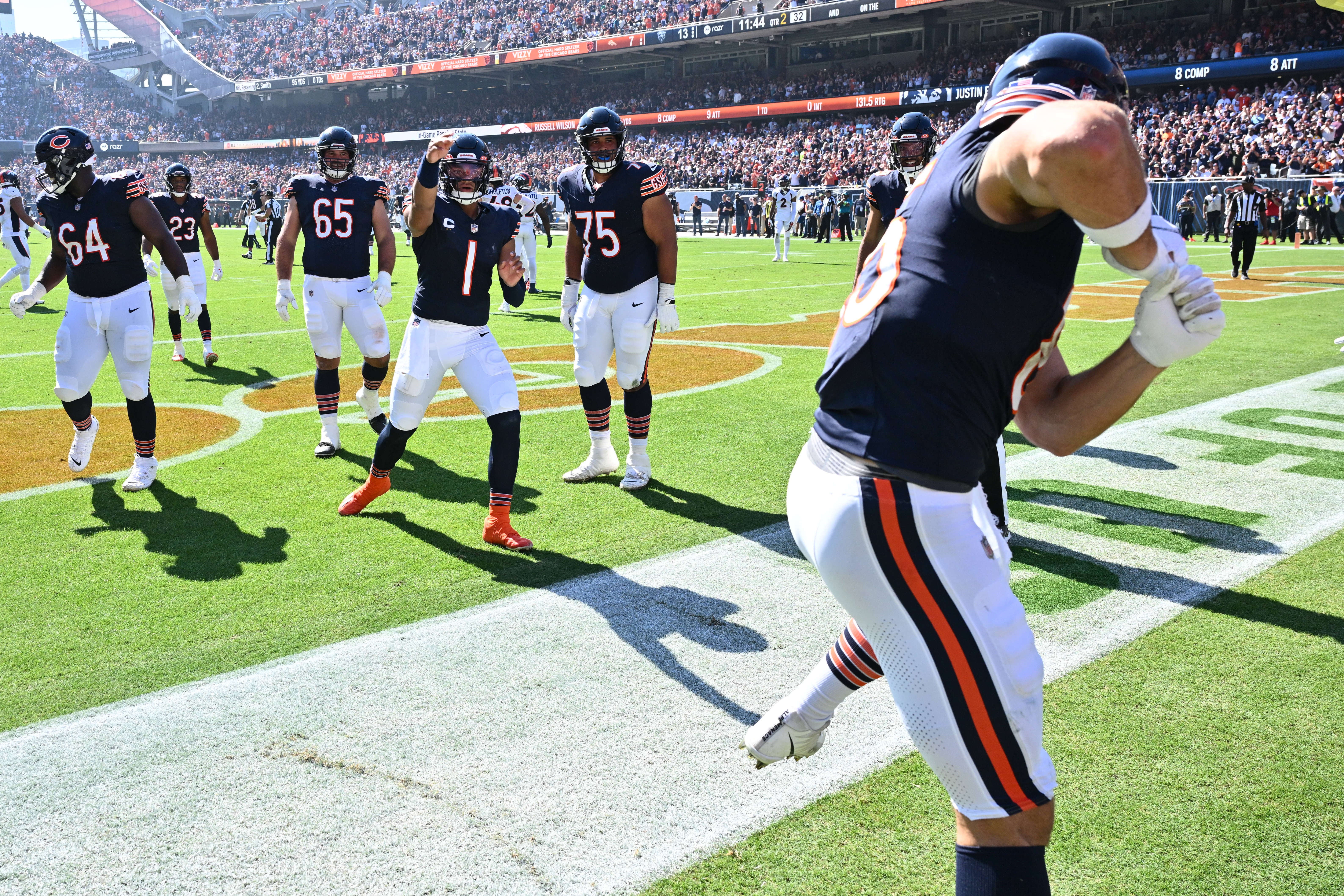 Oct 1, 2023; Chicago, Illinois, USA; Chicago Bears quarterback Justin Fields (1) and tight end Cole Kmet (85) play pitch and bat to celebrate a touchdown pass in the second quarter against the Denver Broncos at Soldier Field.