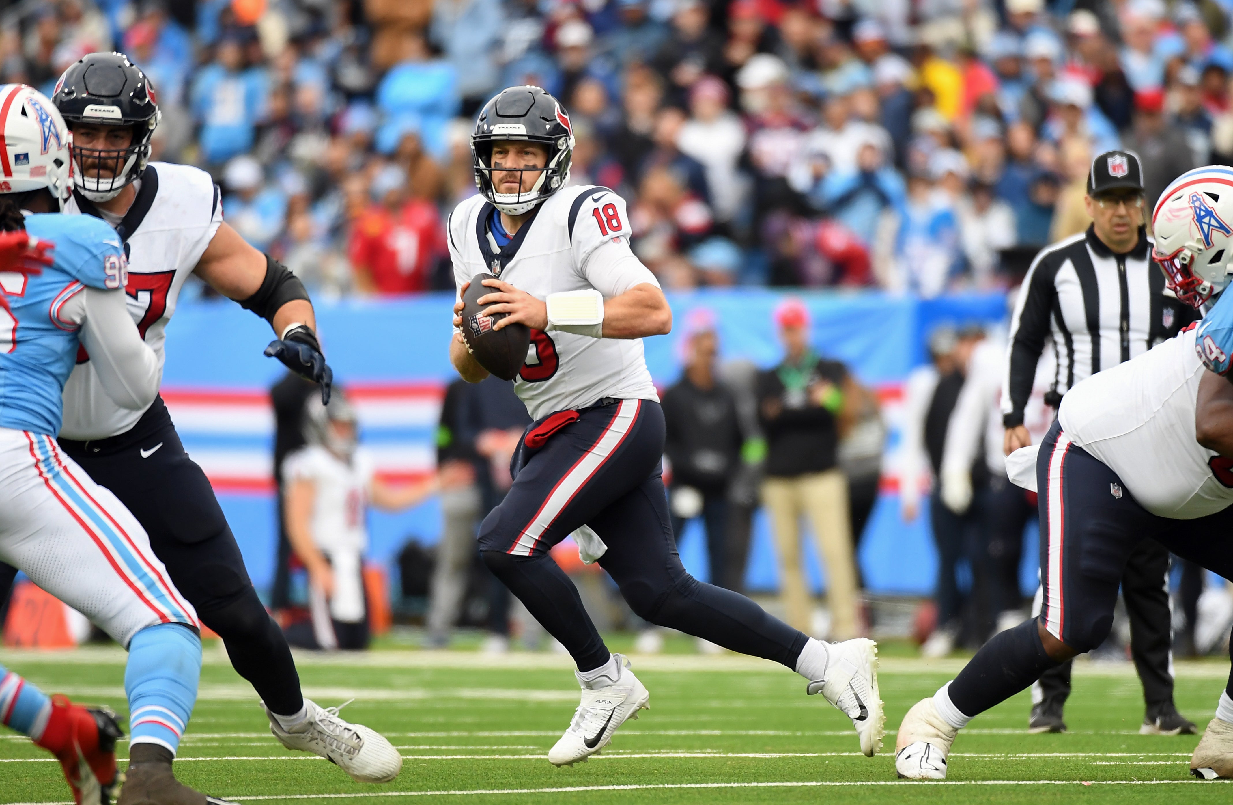 Dec 17, 2023; Nashville, Tennessee, USA; Houston Texans quarterback Case Keenum (18) scrambles against the Tennessee Titans during the first half at Nissan Stadium.