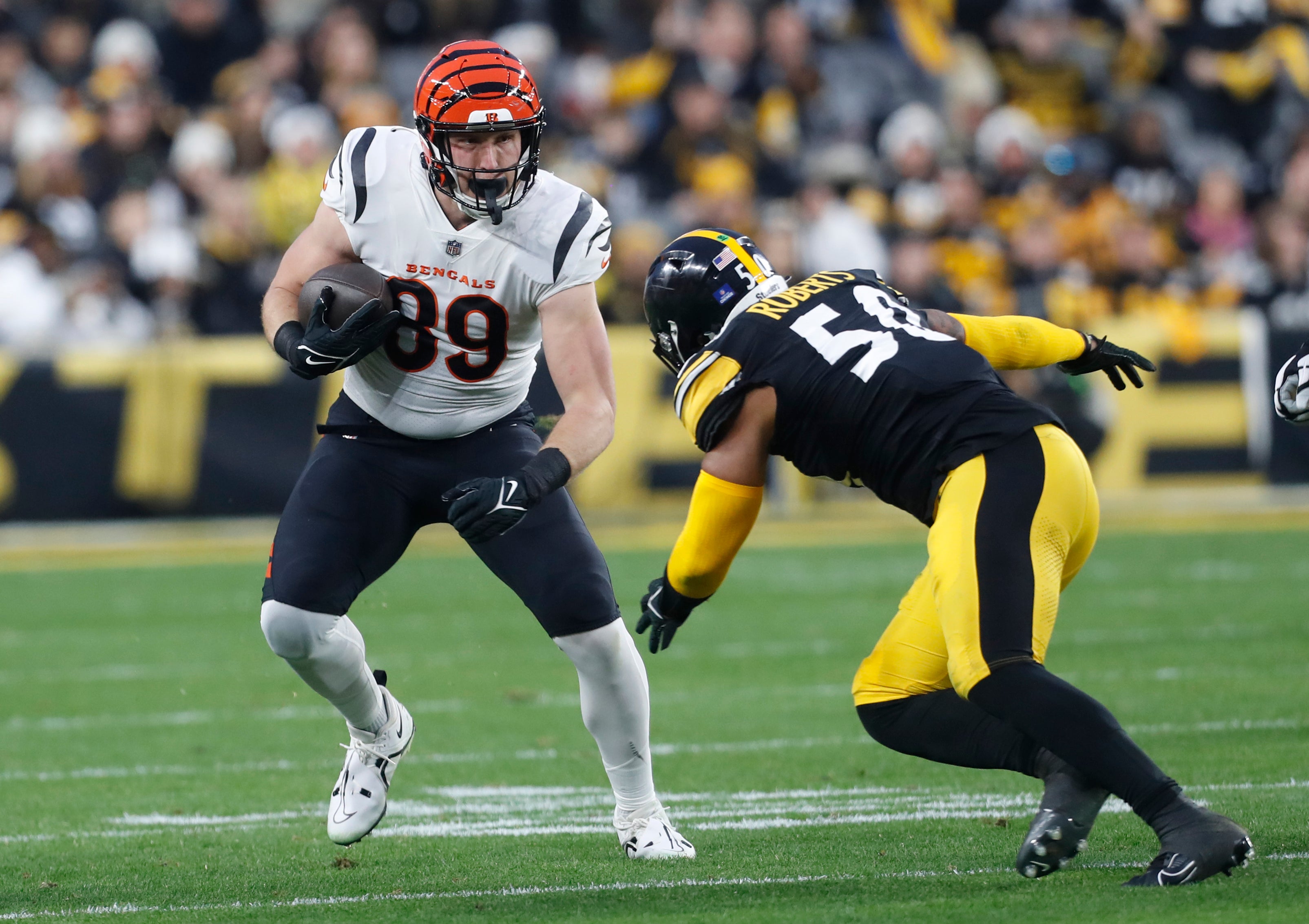 Dec 23, 2023; Pittsburgh, Pennsylvania, USA; Cincinnati Bengals tight end Drew Sample (89) runs after a catch as Pittsburgh Steelers linebacker Elandon Roberts (50) defends during the first quarter at Acrisure Stadium. Mandatory Credit: Charles LeClaire-USA TODAY Sports