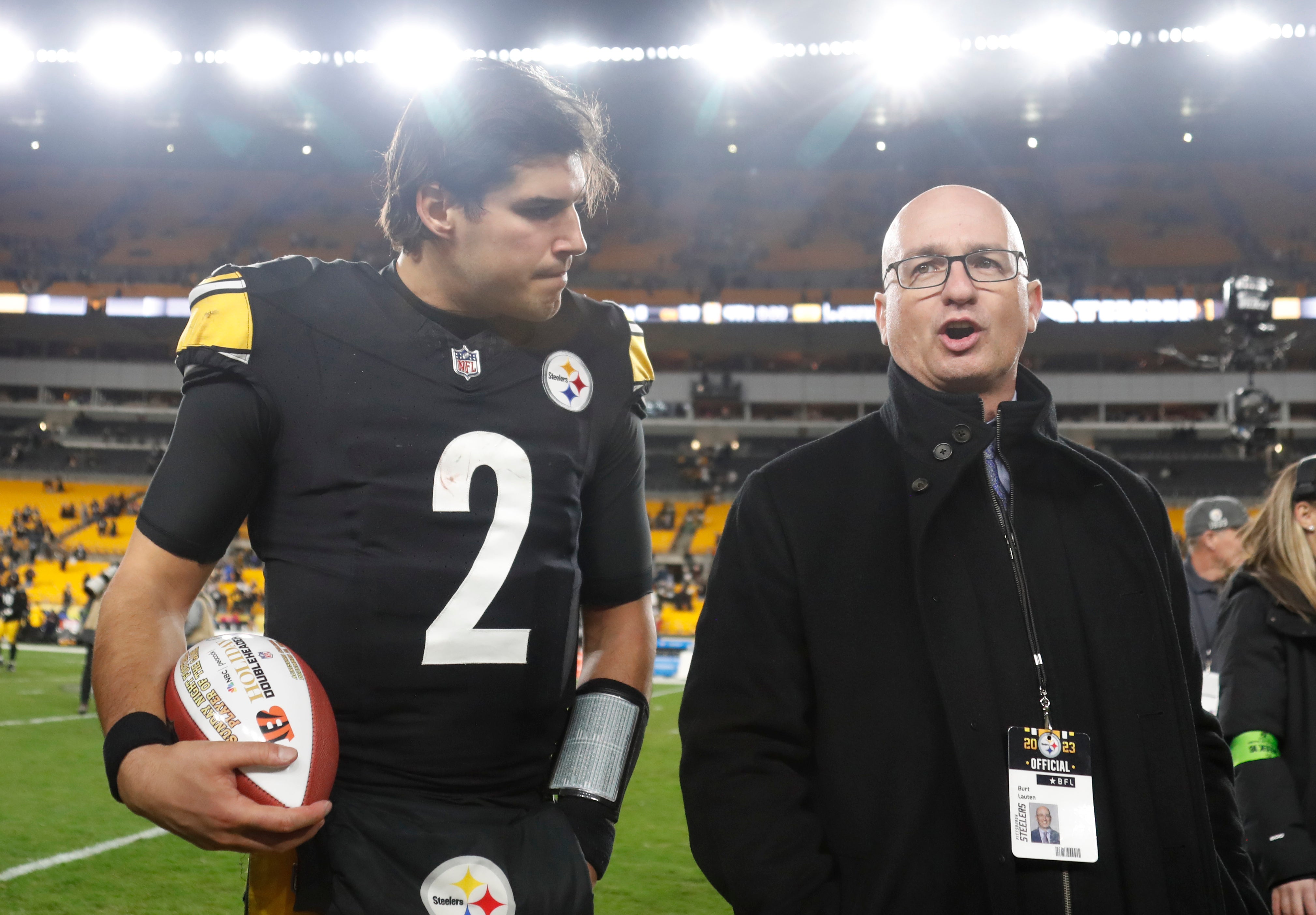 Dec 23, 2023; Pittsburgh, Pennsylvania, USA; Pittsburgh Steelers quarterback Mason Rudolph (2) leaves the field with Steelers Senior Director of Communications Burt Lauten (right) after defeating the Cincinnati Bengals at Acrisure Stadium. Pittsburgh won 34-11. Mandatory Credit: Charles LeClaire-USA TODAY Sports