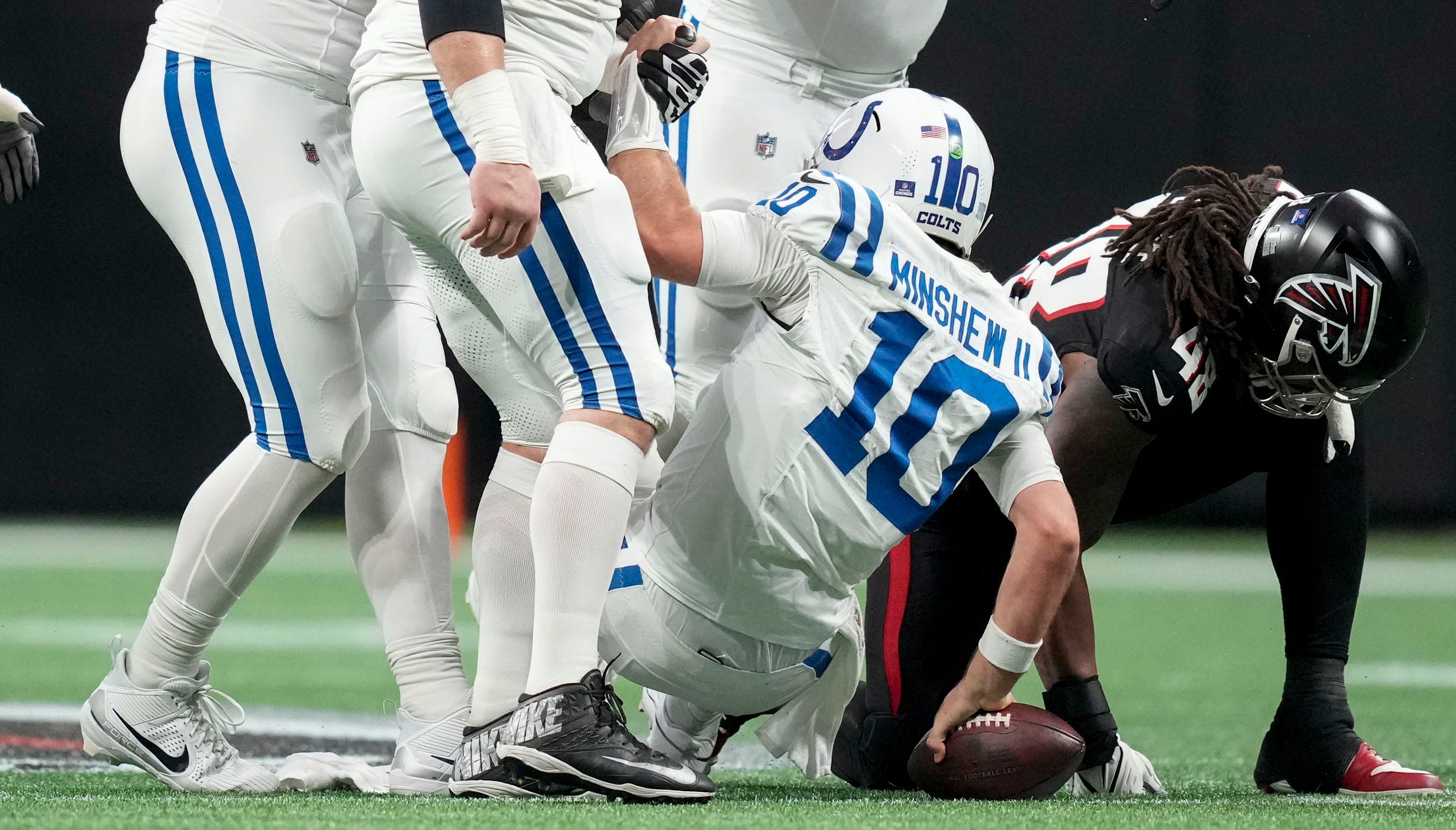 Indianapolis Colts quarterback Gardner Minshew II (10) is helped up from the turf after a sack by Sunday, Dec. 24, 2023, during a game against the Atlanta Falcons at Mercedes-Benz Stadium in Atlanta.