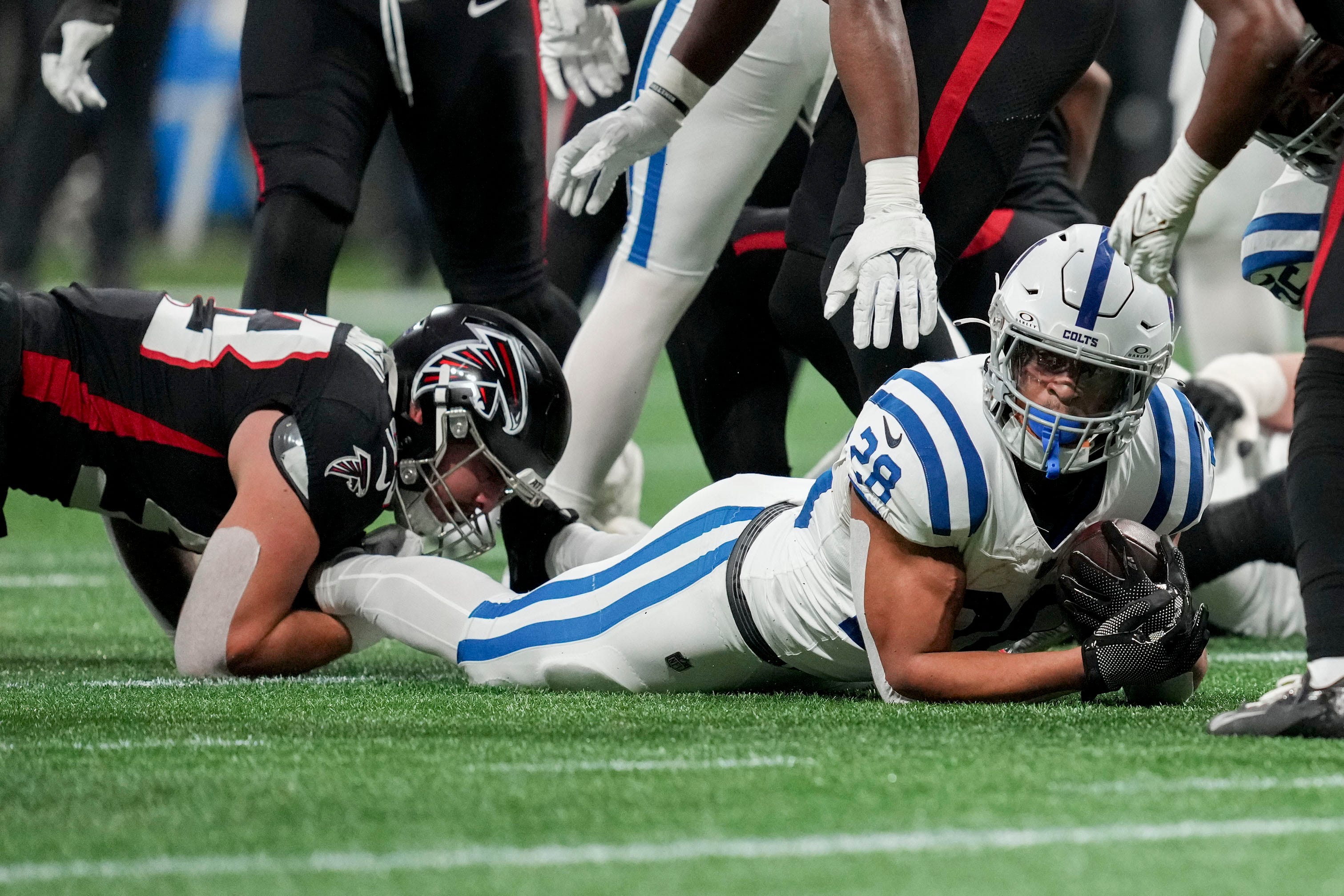 Indianapolis Colts running back Jonathan Taylor (28) dives with the ball Sunday, Dec. 24, 2023, during a game against the Atlanta Falcons at Mercedes-Benz Stadium in Atlanta.