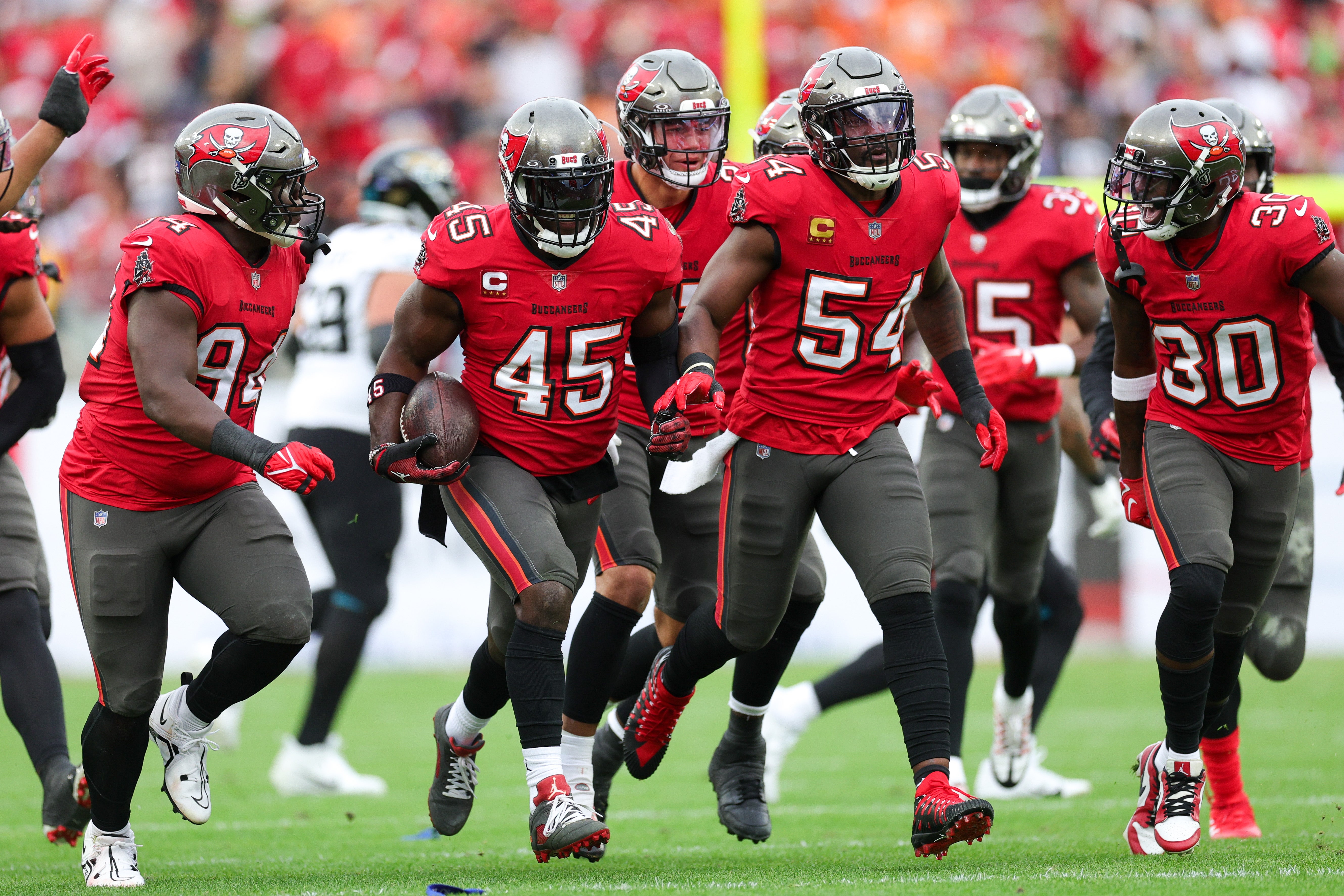 Dec 24, 2023; Tampa, Florida, USA; Tampa Bay Buccaneers linebacker Devin White (45) celebrates after intercepting the ball against the Jacksonville Jaguars in the first quarter at Raymond James Stadium. Mandatory Credit: Nathan Ray Seebeck-USA TODAY Sports