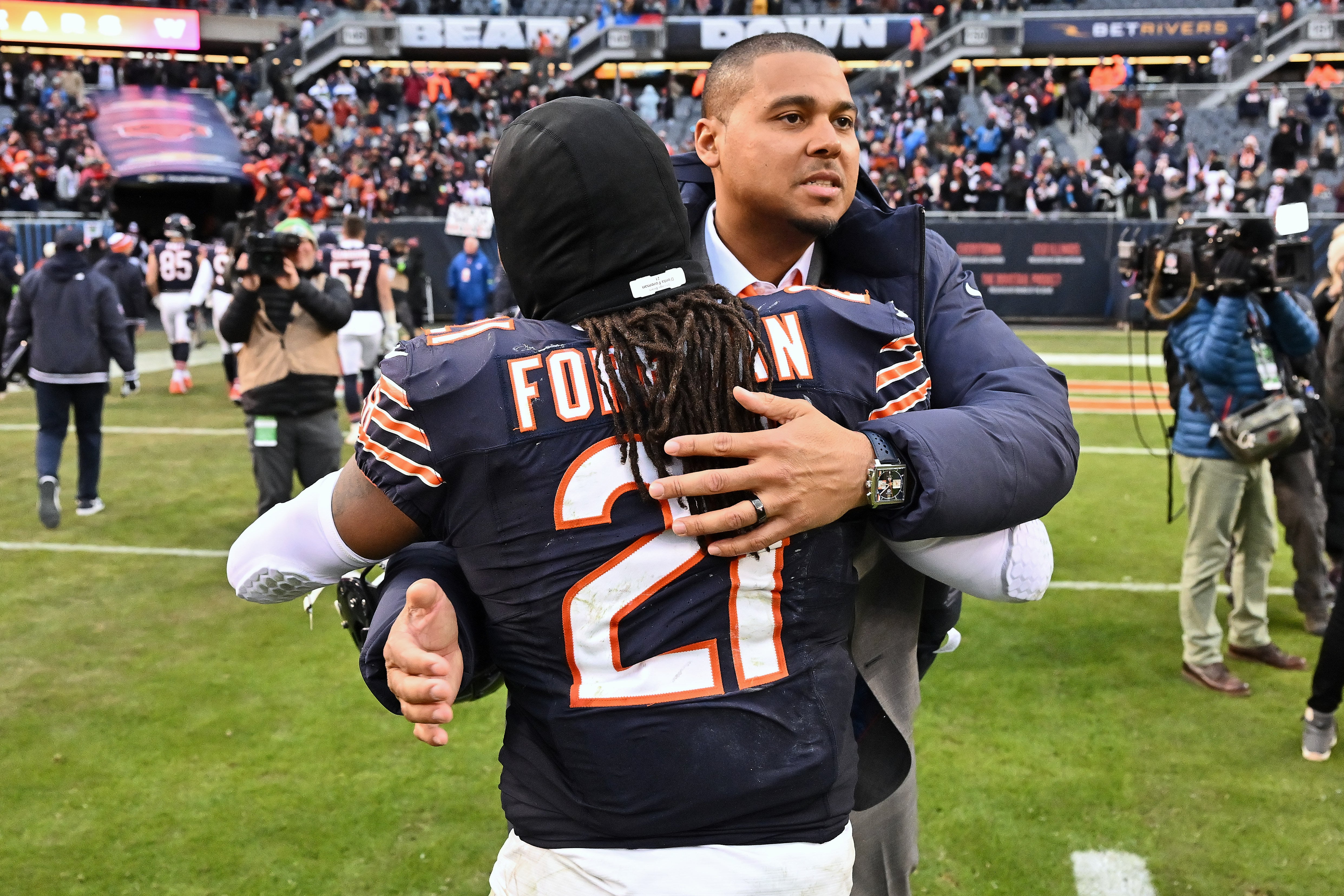 Dec 10, 2023; Chicago, Illinois, USA; Chicago Bears general manager Ryan Poles celebrates with running back D'Onta Foreman (21) after Chicago defeated the Detroit Lions at Soldier Field.