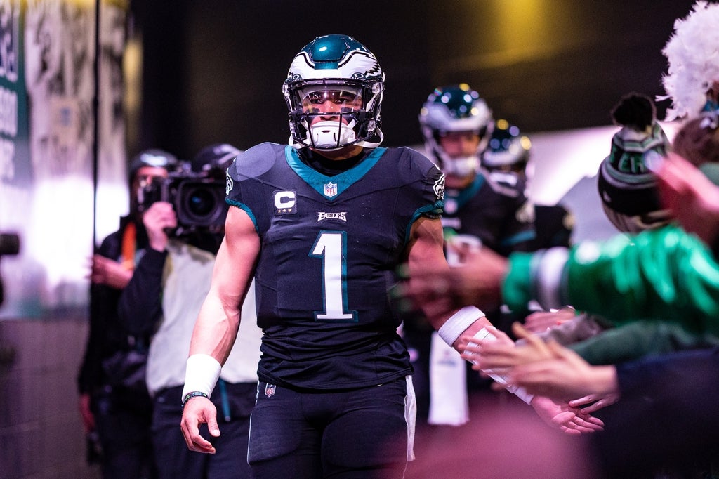 Philadelphia Eagles quarterback Jalen Hurts (1) high fives fans as he walks from the locker room for a game against the New York Giants at Lincoln Financial Field.