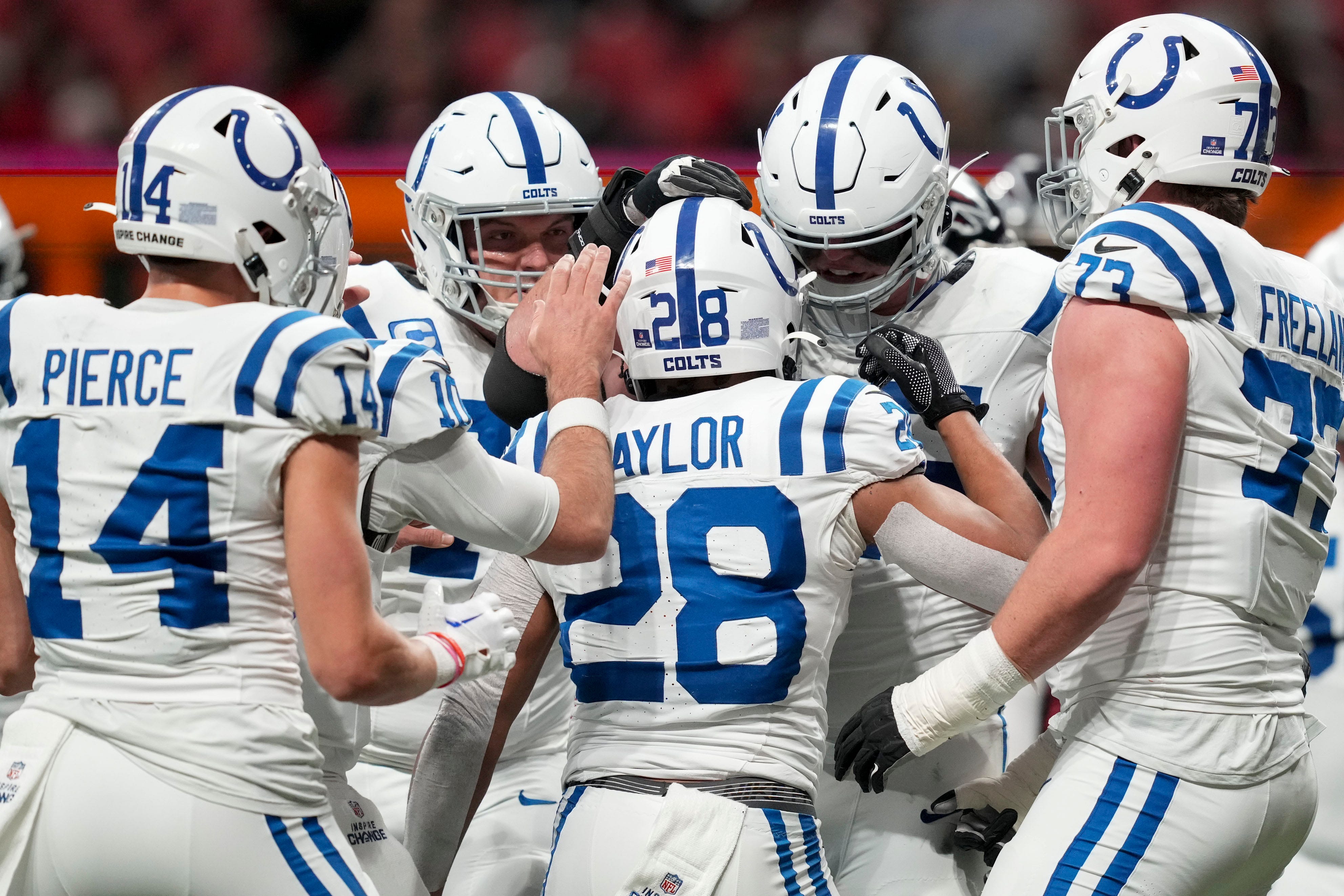Indianapolis Colts running back Jonathan Taylor (28) celebrates with his teammates after rushing for a touchdown Sunday, Dec. 24, 2023, during a game against the Atlanta Falcons at Mercedes-Benz Stadium in Atlanta.