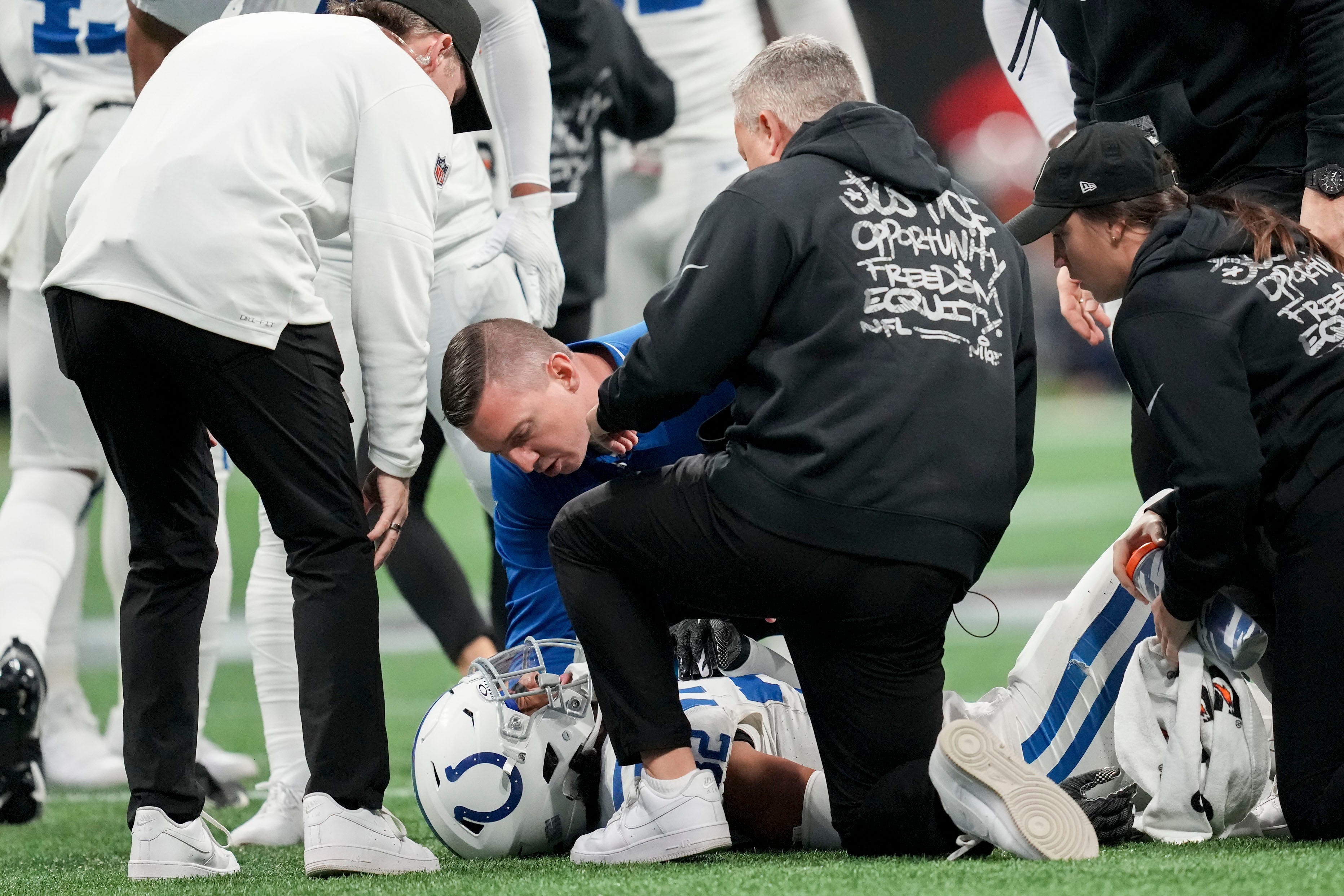 Training crew tend to Indianapolis Colts safety Julian Blackmon (32) on Sunday, Dec. 24, 2023, during a game against the Atlanta Falcons at Mercedes-Benz Stadium in Atlanta.