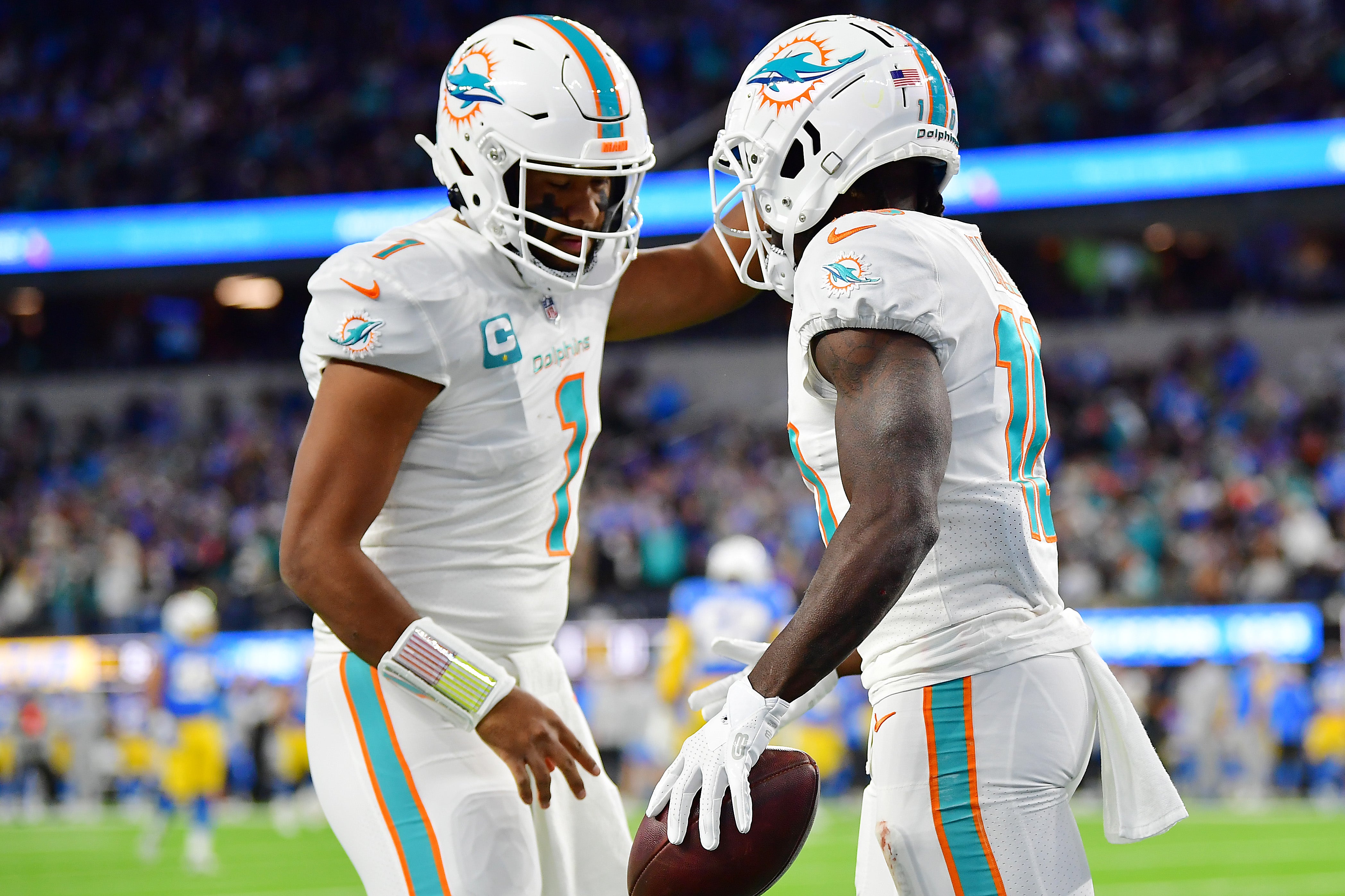 Miami Dolphins wide receiver Tyreek Hill celebrates his touchdown scored against the Los Angeles Chargers with quarterback Tua Tagovailoa during the first half at SoFi Stadium.