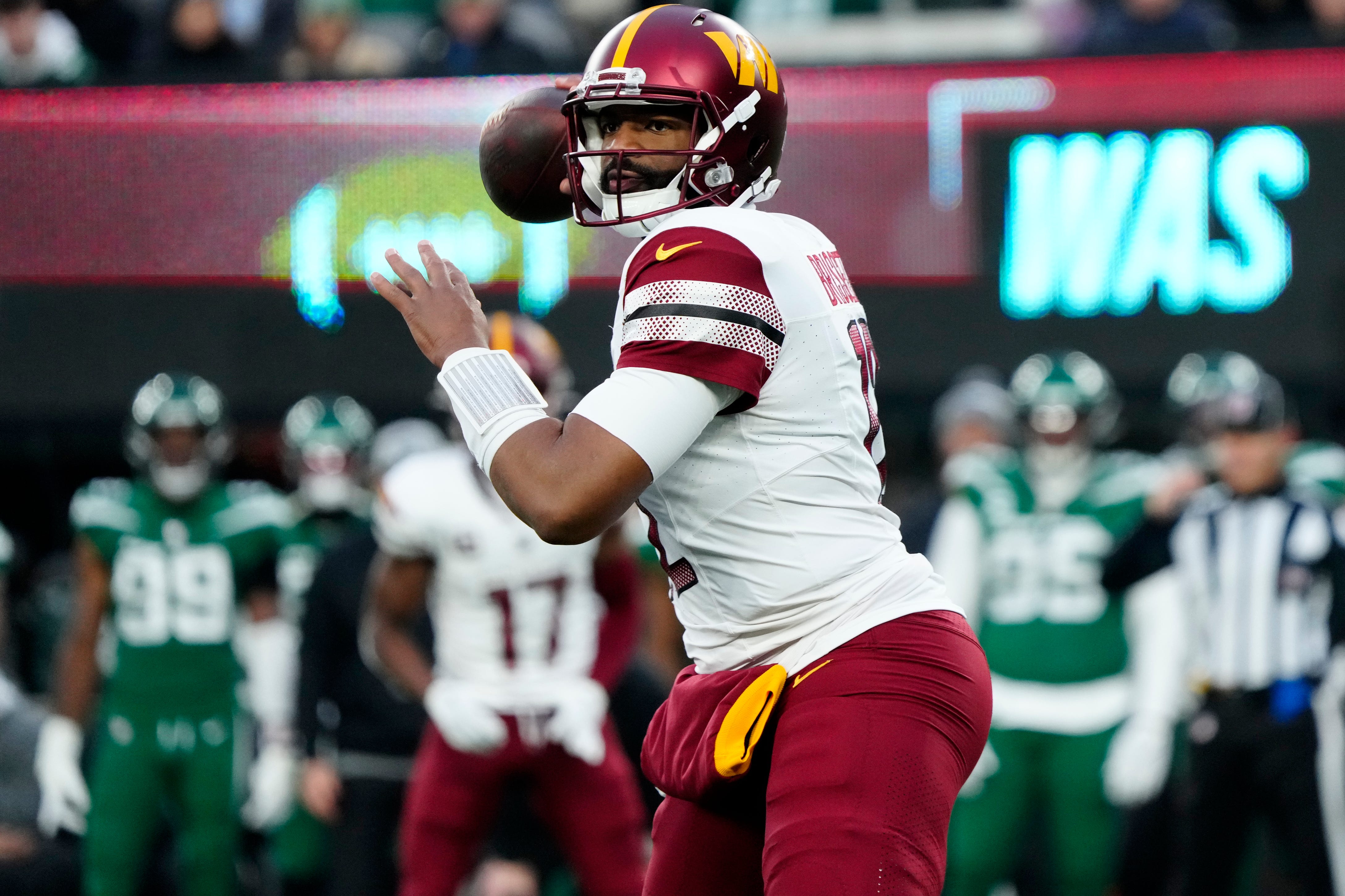 Washington Commanders quarterback Jacoby Brissett (12) gets ready to throw a pass at MetLife Stadium, Sunday December 24, 2023.