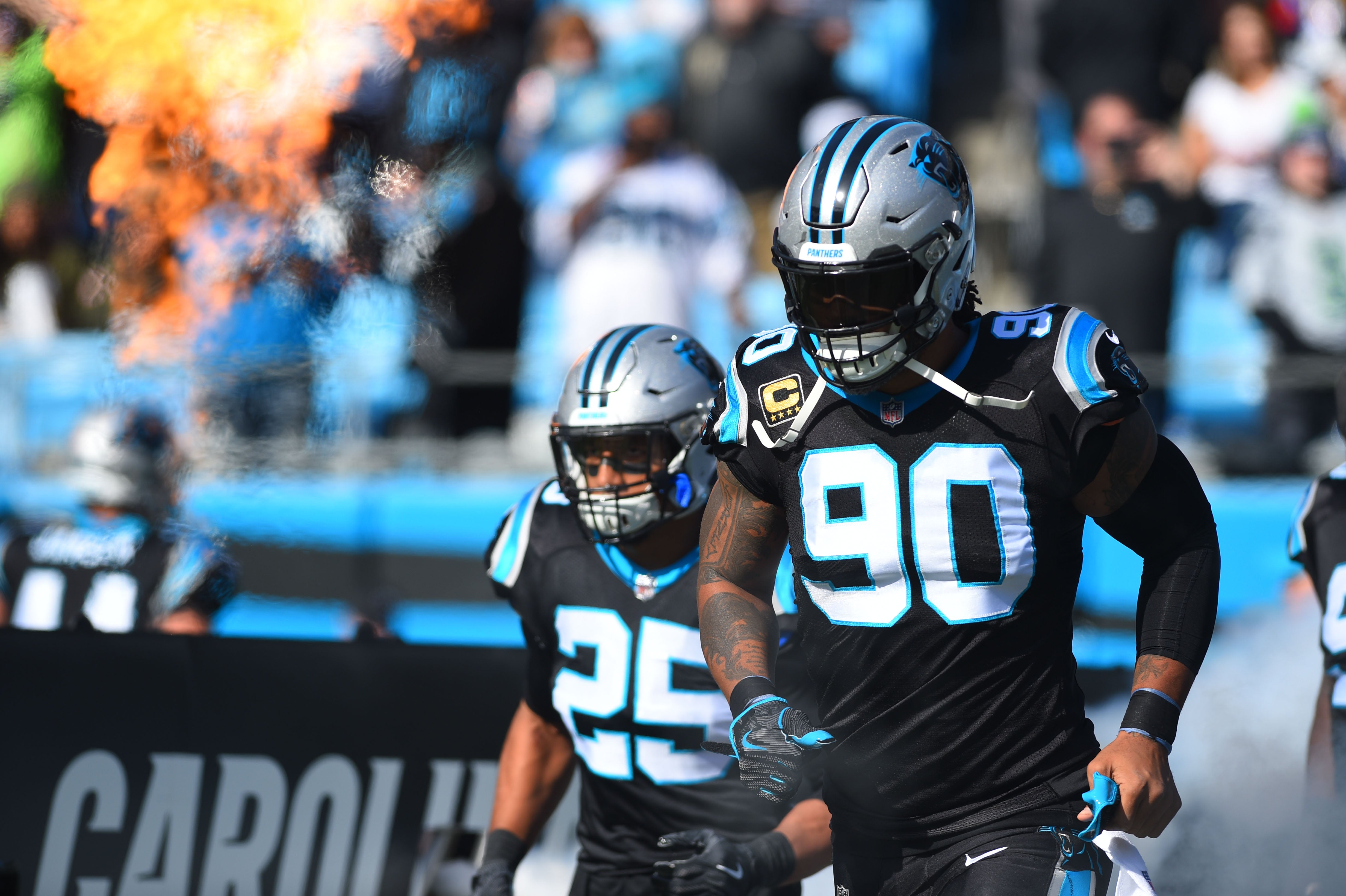 Nov 25, 2018; Charlotte, NC, USA; Carolina Panthers defensive back Damian Parms (25) and defensive end Julius Peppers (90) run on to the field before the game at Bank of America Stadium. Mandatory Credit: Bob Donnan-USA TODAY Sports