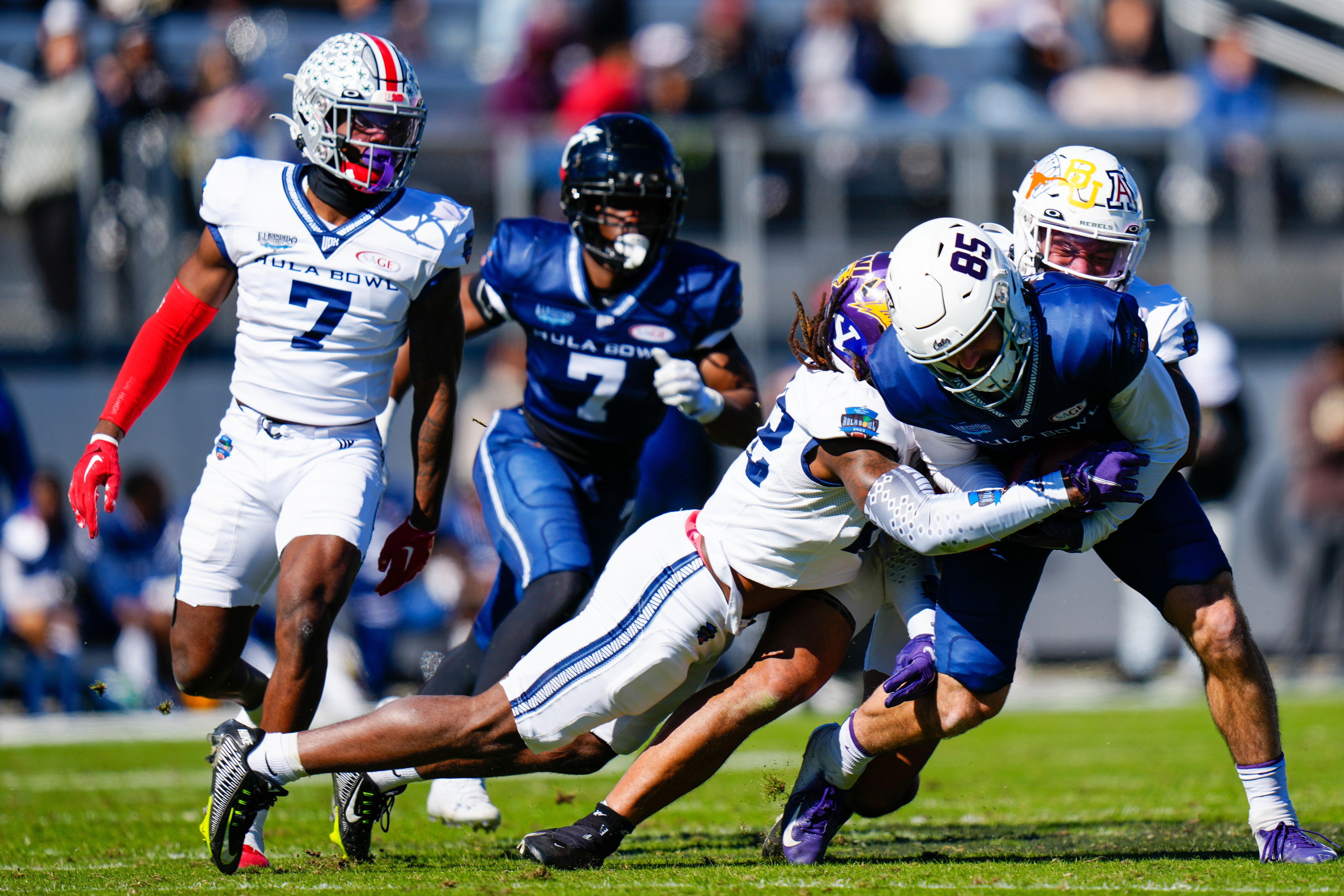 Jan 14, 2023; Orlando, FL, USA; Team Kai linebacker Austin Ajiake (32) of the UNLV Rebels tackles Team Aina tight end Julian Hill (85) of the Campbell Fighting Camels during the second quarter in the 2023 Hula Bowl at UCF FBC Mortgage Stadium.