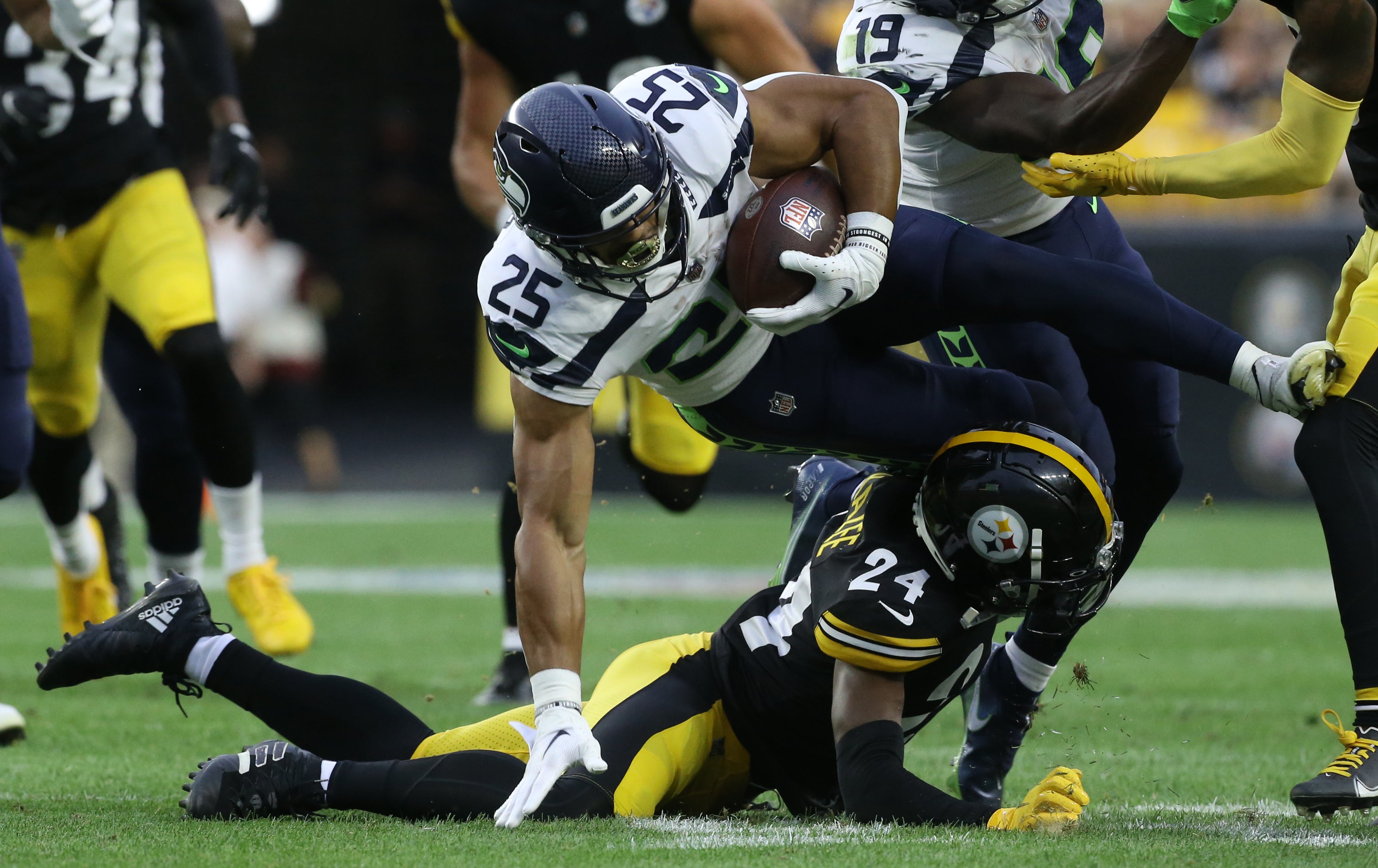 Aug 13, 2022; Pittsburgh, Pennsylvania, USA; Seattle Seahawks running back Travis Homer (25) is tackled by safety Damontae Kazee (24) during the second quarter against at Acrisure Stadium. The Steelers won 32-25. Mandatory Credit: Charles LeClaire-USA TODAY Sports