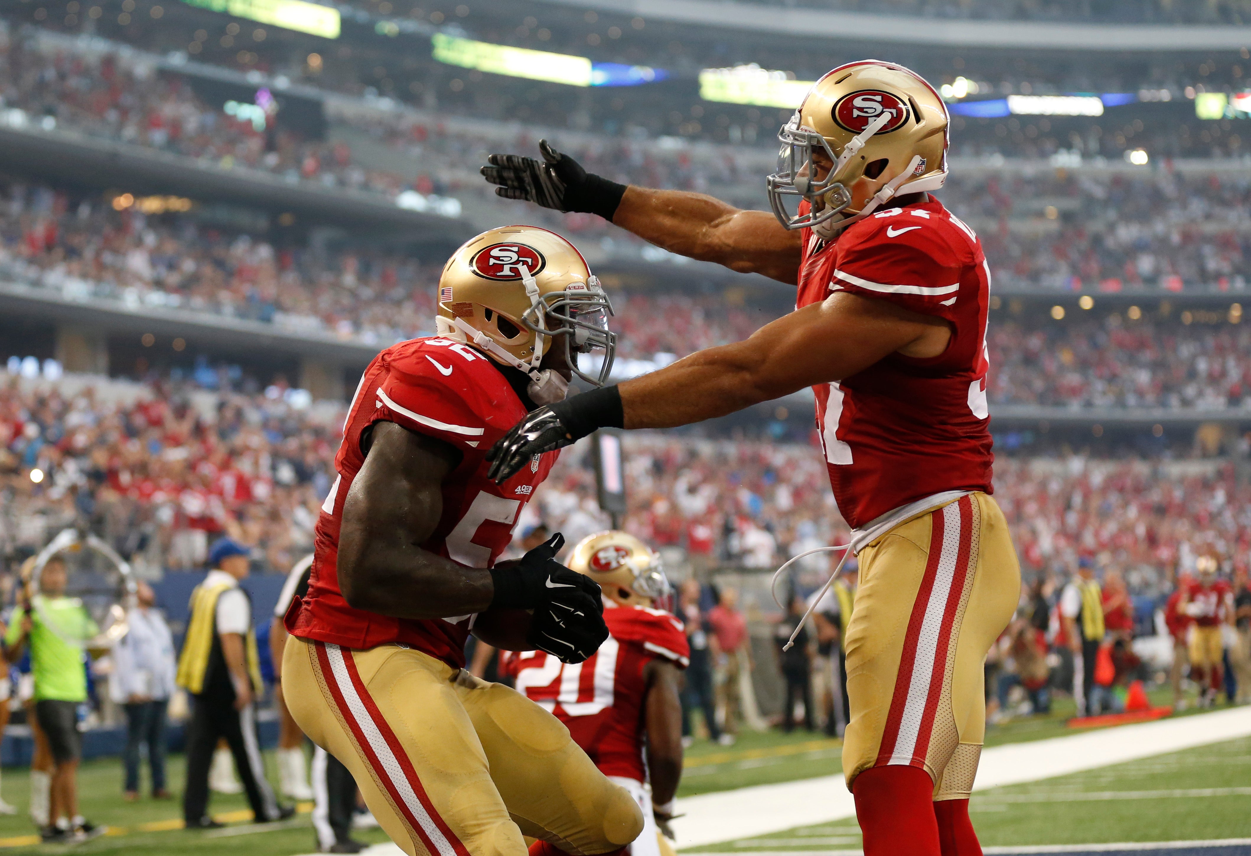 Sep 7, 2014; Arlington, TX, USA; San Francisco 49ers linebacker Patrick Willis (52) celebrates his interception in the end zone with linebacker Michael Wilhoite (57) against the Dallas Cowboys at AT&T Stadium.