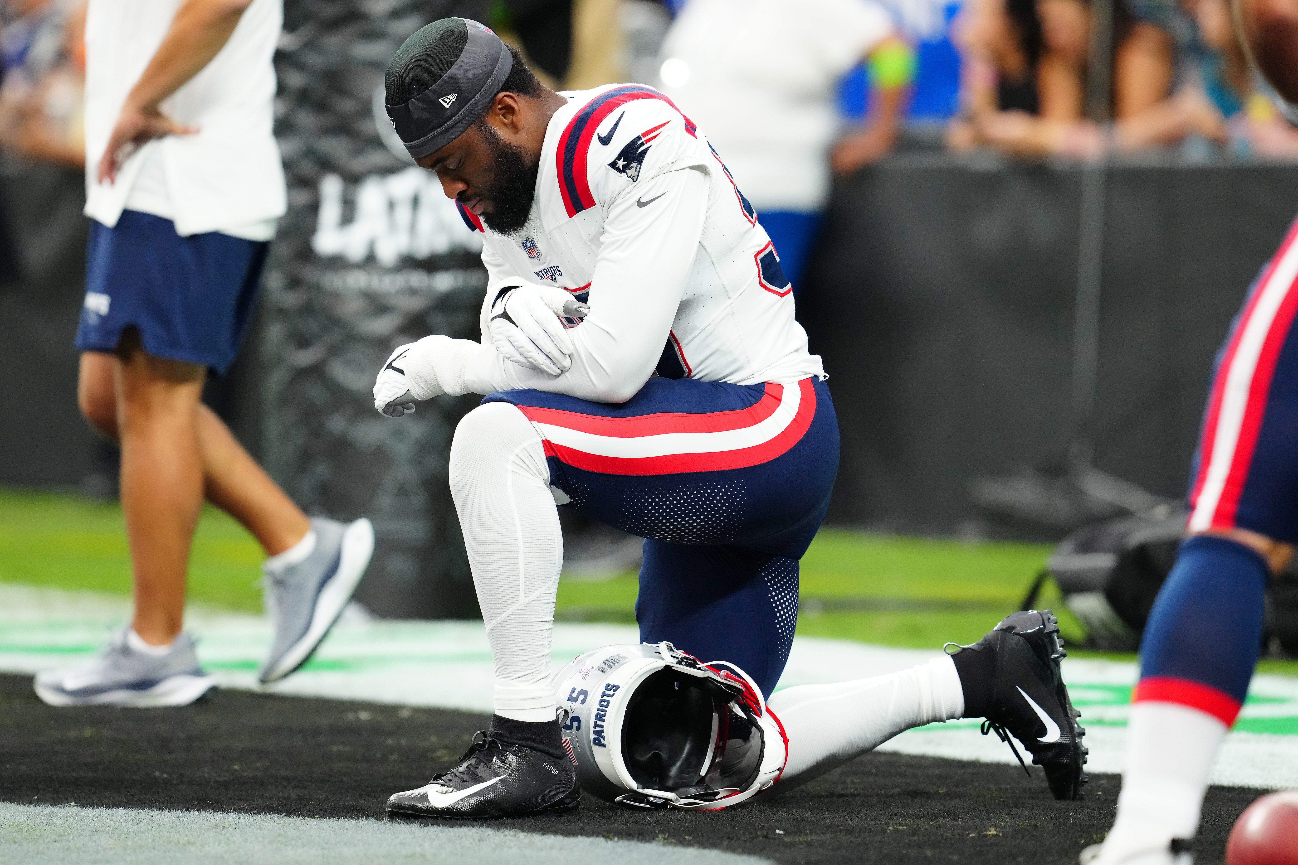 New England Patriots linebacker Josh Uche prays before the start of a game against the Las Vegas Raiders at Allegiant Stadium