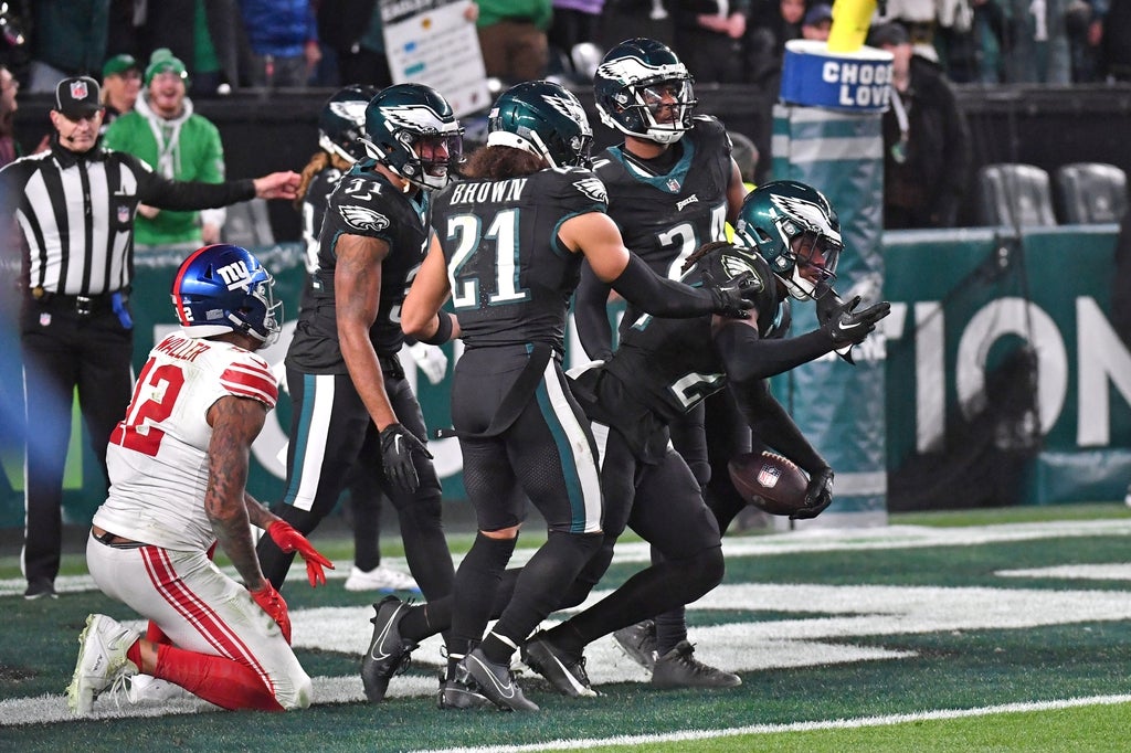 Philadelphia Eagles cornerback Kelee Ringo (22) celebrates his interception with teammates on final play of win against the New York Giants at Lincoln Financial Field.